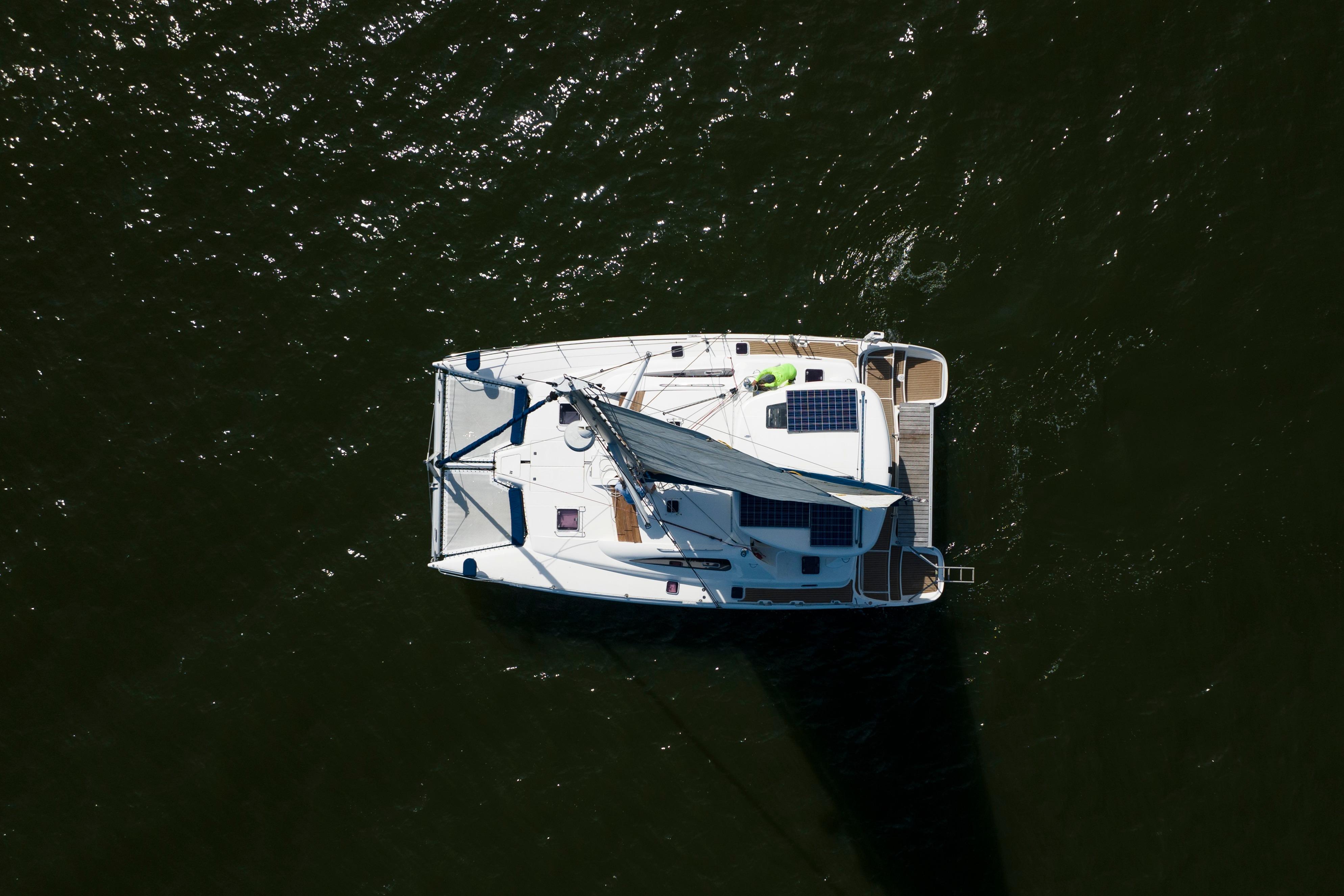 Aerial view of 2006 Leopard 43 catamaran sailing on dark water.