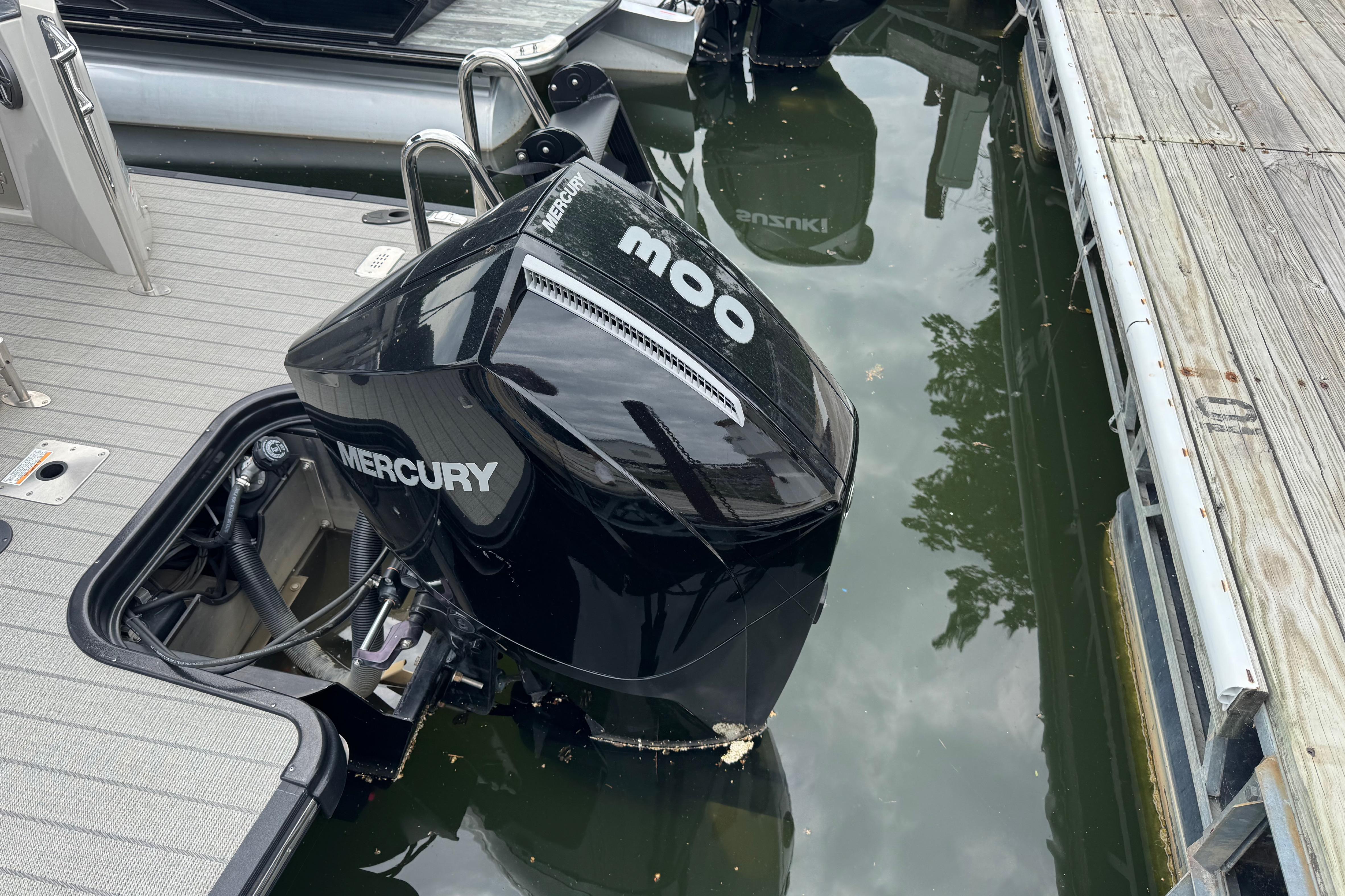 2023 Starcraft MX 25 DL DH boat with Mercury outboard engine docked.