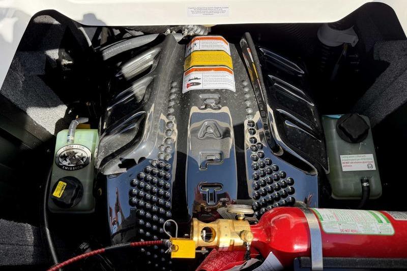 Engine compartment of a 2026 Supra SL with visible components and safety equipment.