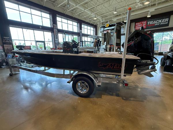 2025 Mako 18 Pro Skiff Backwater Edition displayed indoors on a trailer.