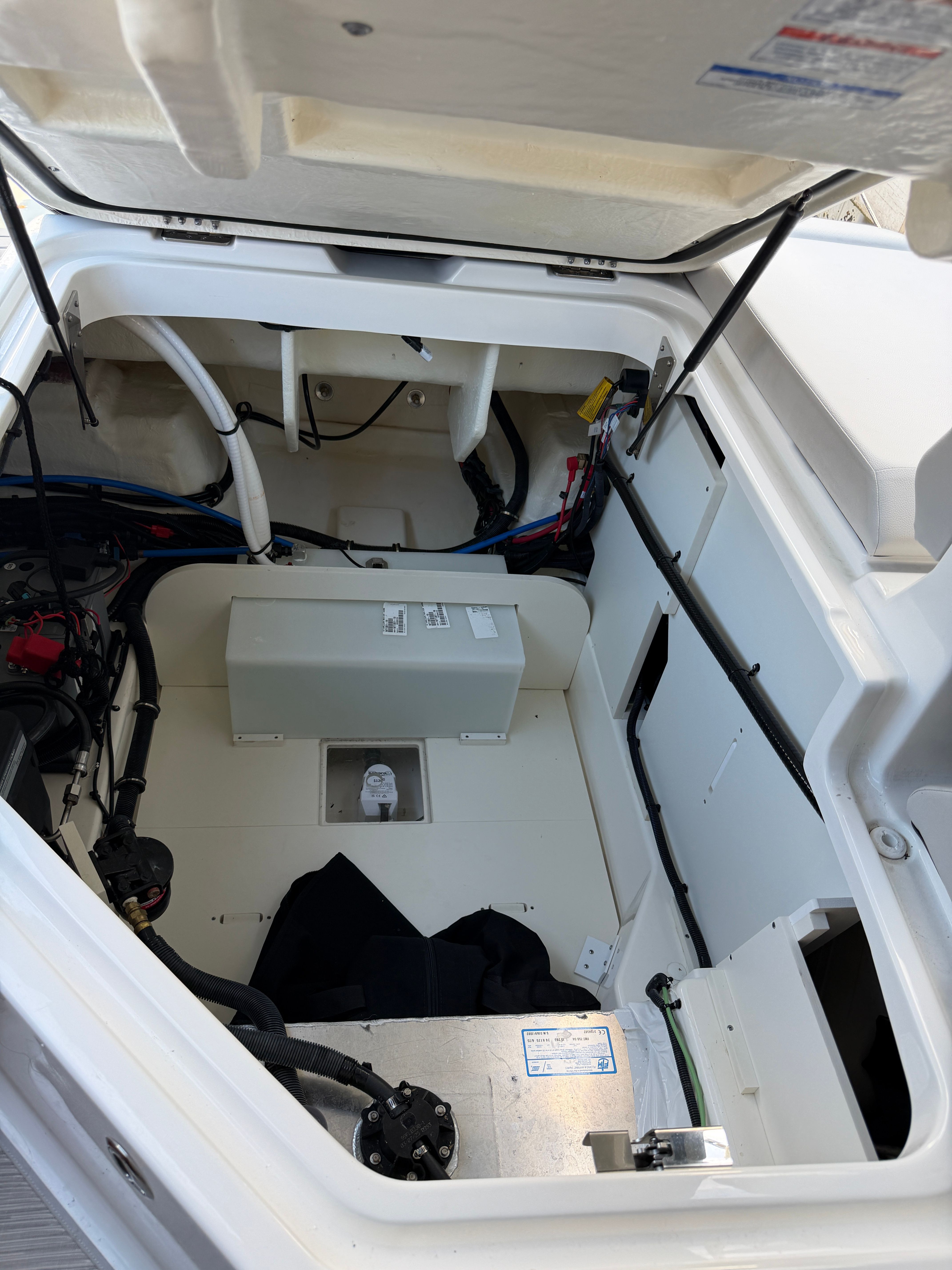 Interior view of the 2025 Sea Ray SDX 250 Outboard showing storage and wiring.