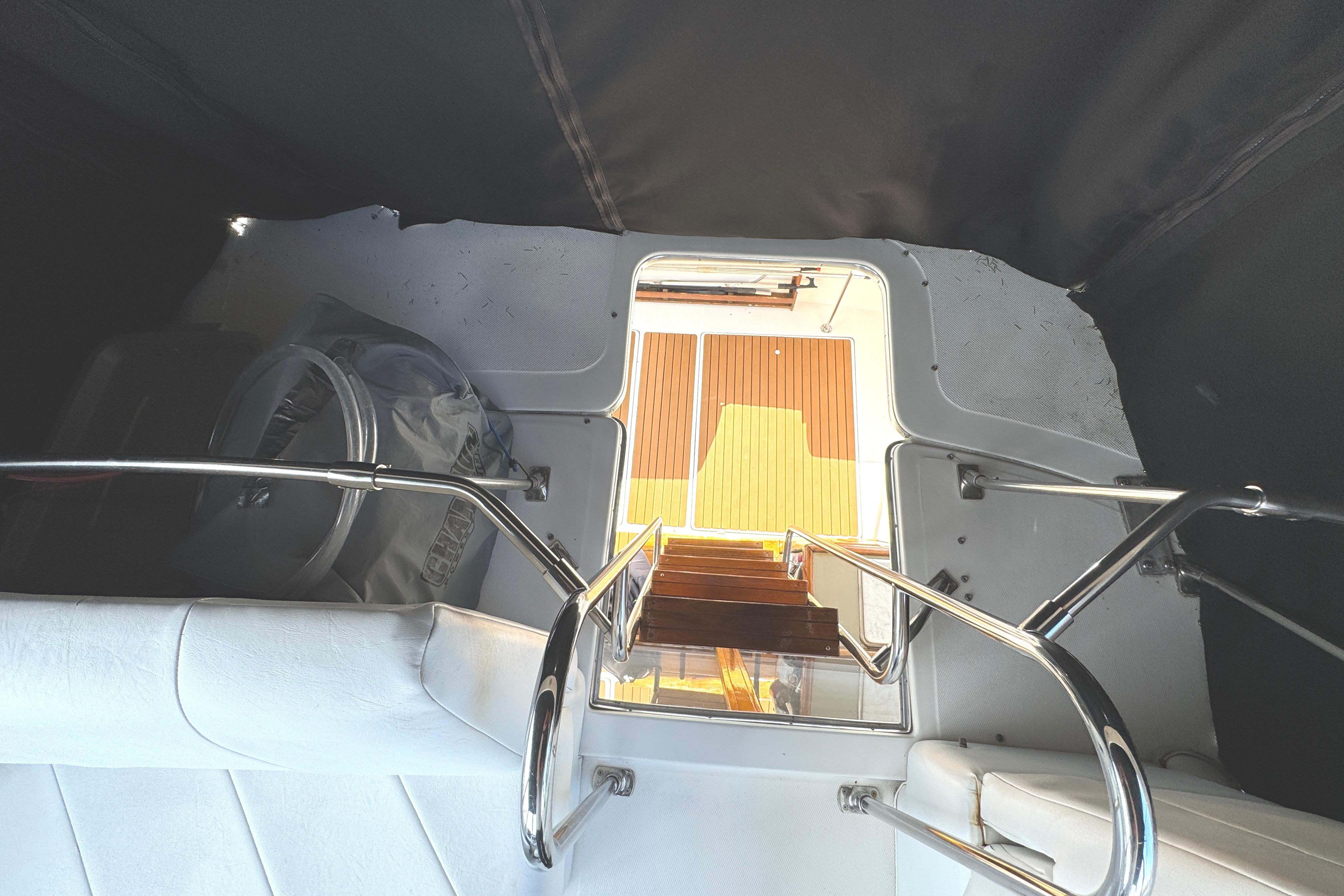 Interior view of 1995 Bayliner 3288 Motoryacht with seating and wooden steps.
