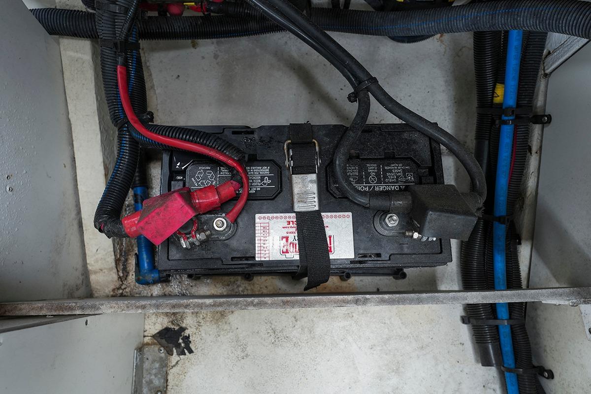 Battery compartment of a 2018 Sea Ray SLX 350 boat with cables and connectors.