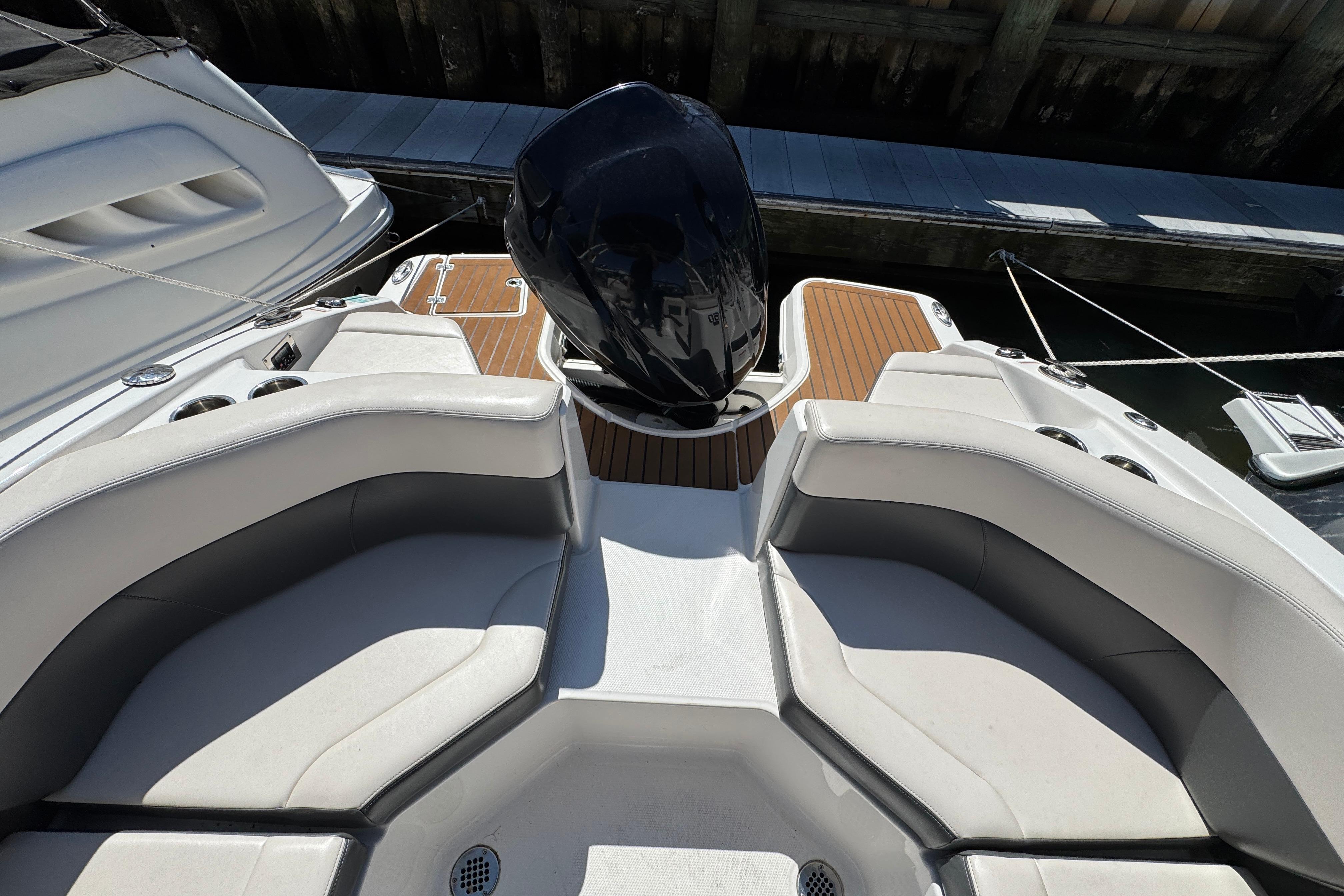 2018 Chaparral 250 Suncoast boat interior with seating and outboard motor.