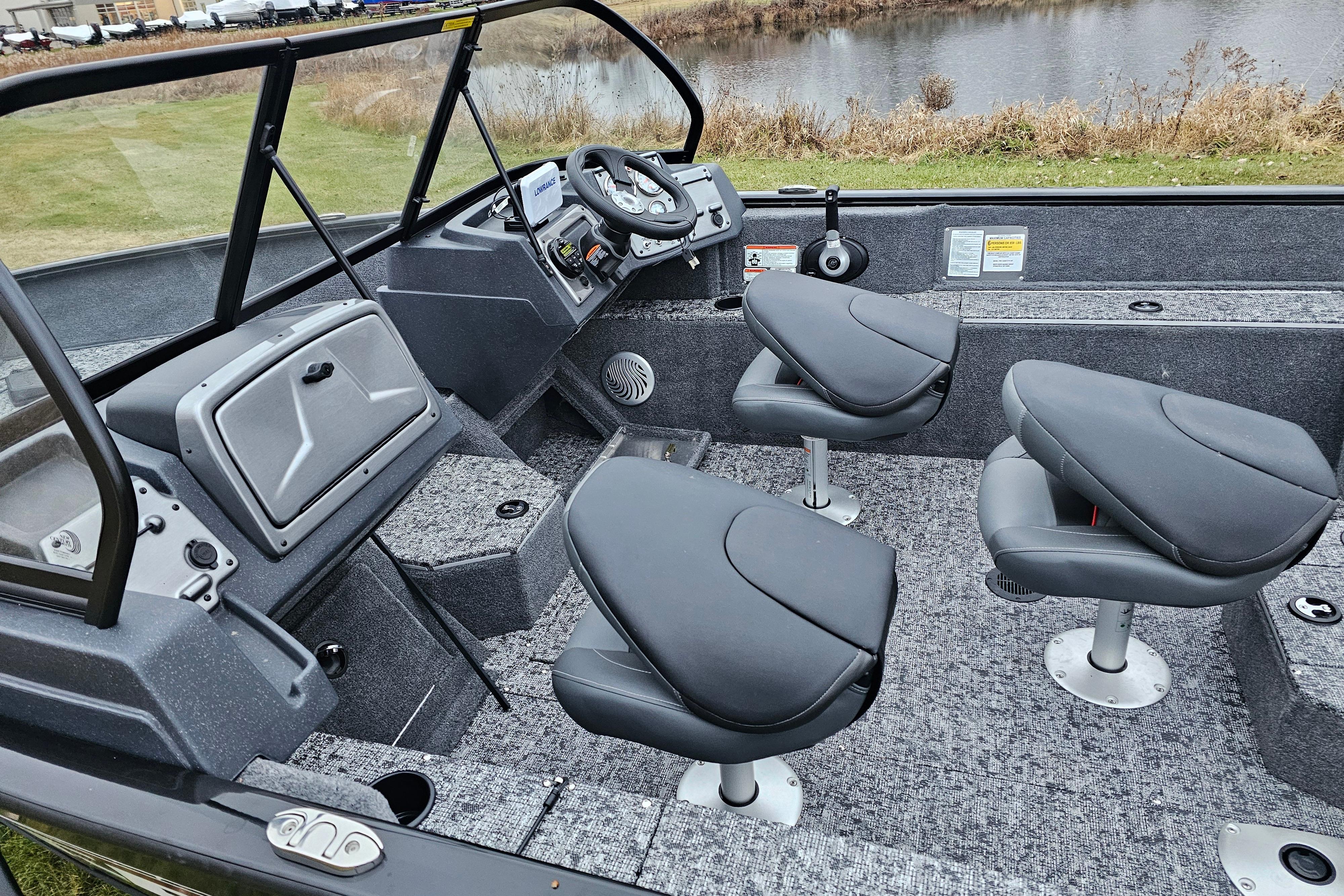 2026 Tracker Pro Guide V-175 WT boat interior with swivel seats and steering console.