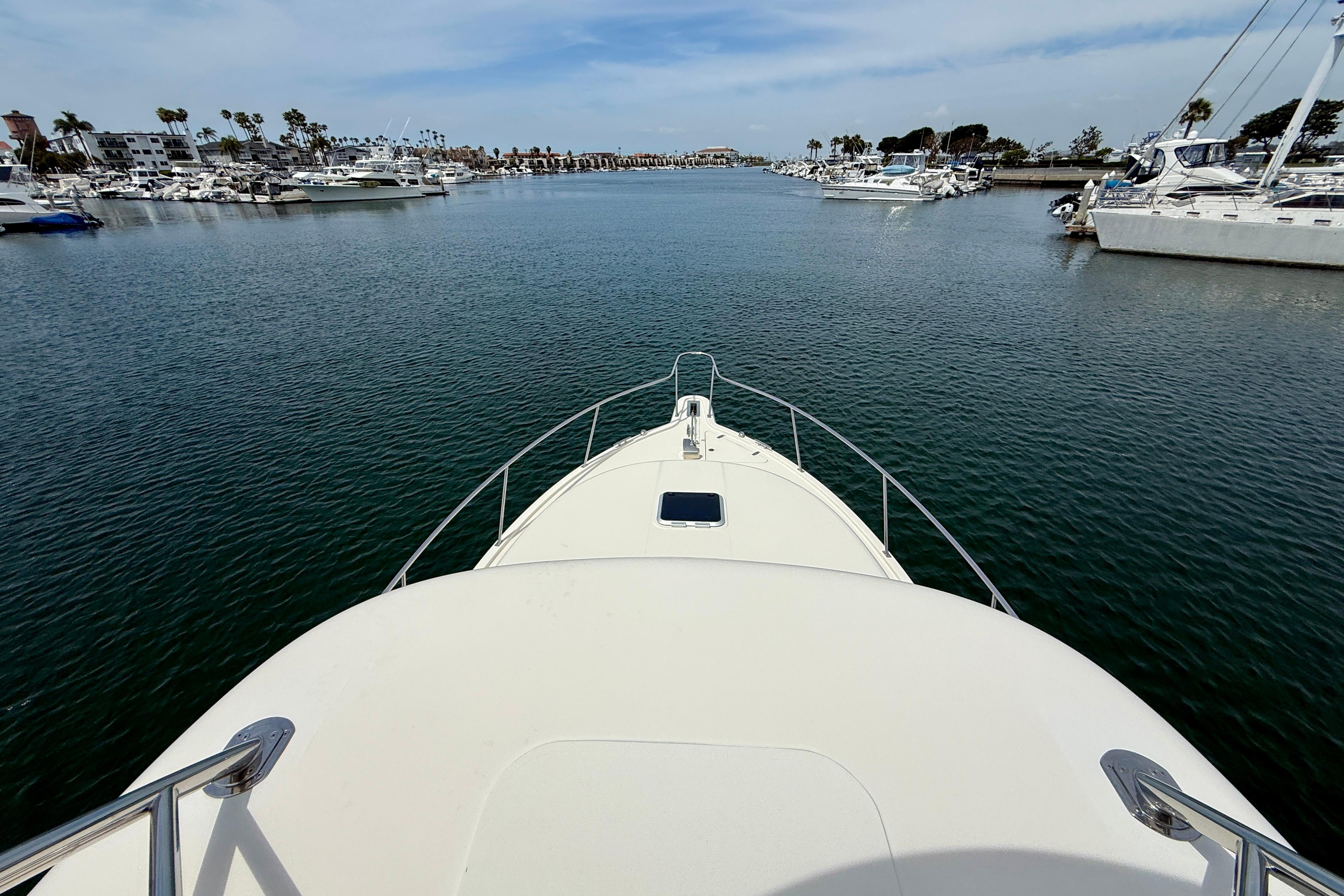 Bow view of 2012 Pursuit OS 345 Offshore yacht in a marina with calm waters.