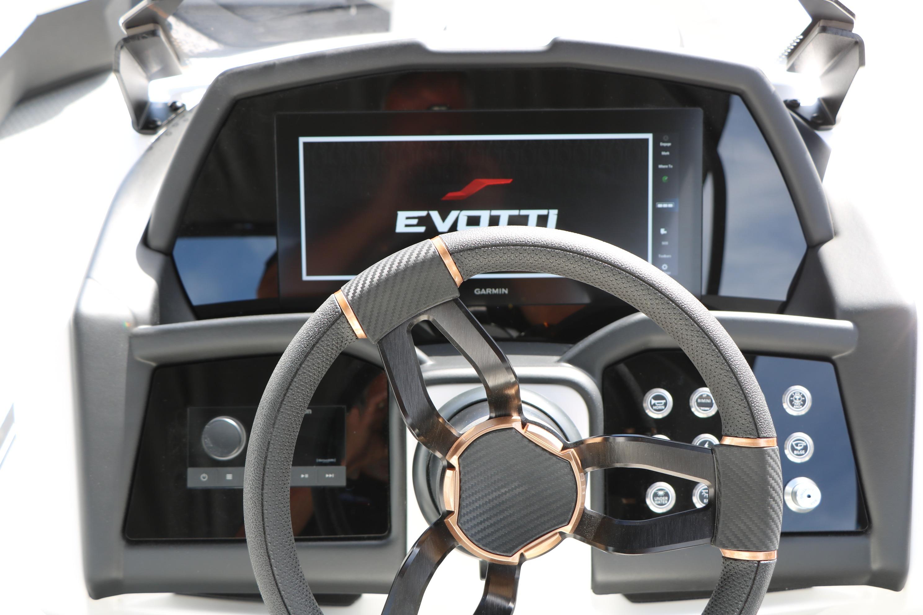 Steering wheel and dashboard of 2026 Evotti 725 CS Tri-Toon boat, featuring modern controls.