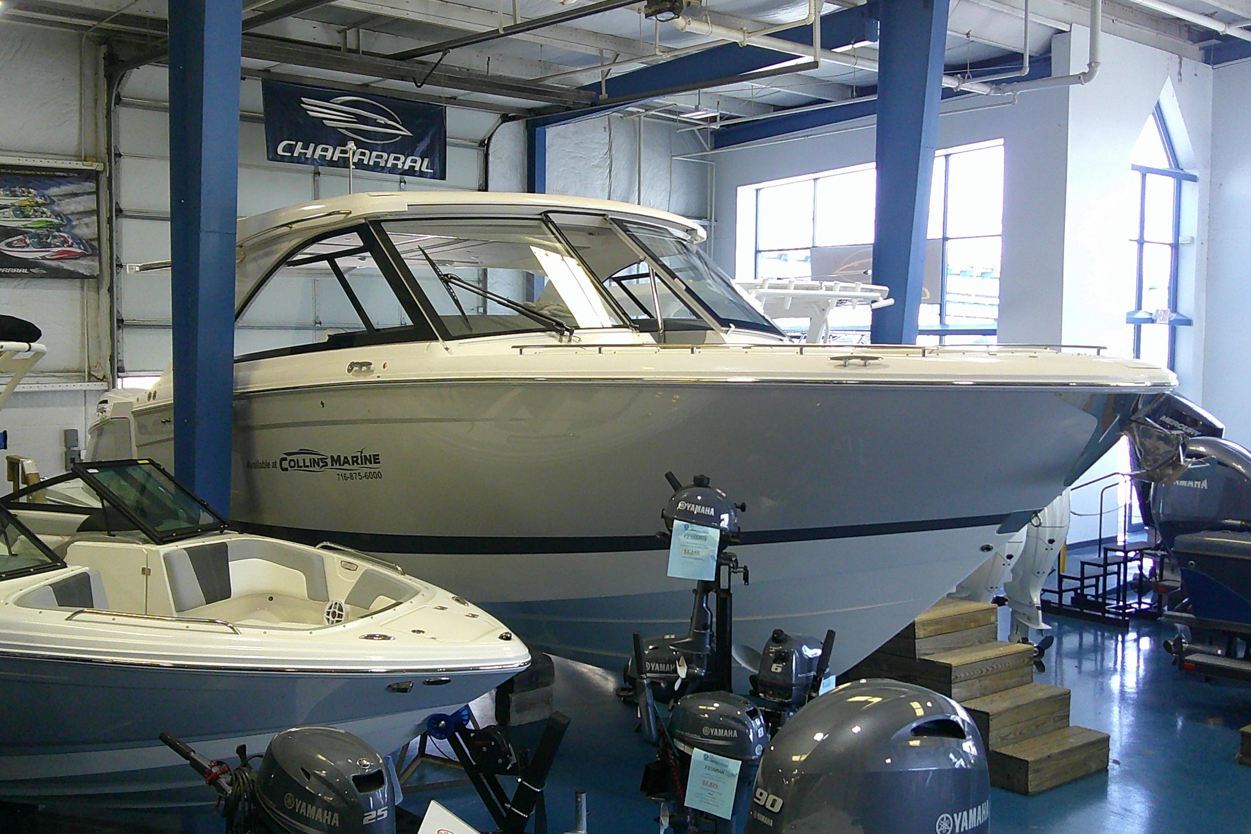 2023 Regal LX36 boat displayed in showroom with Yamaha engines.