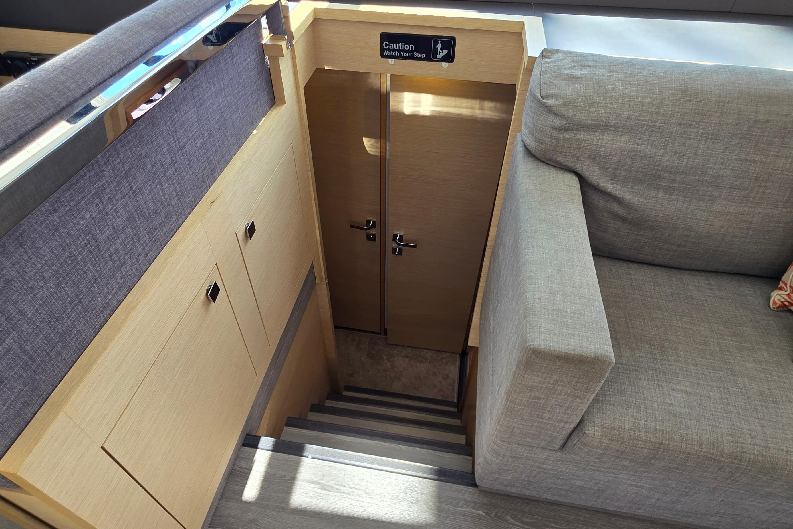 Interior stairs of 2018 Fountaine Pajot Motor Yacht 44, featuring modern design and cozy seating.