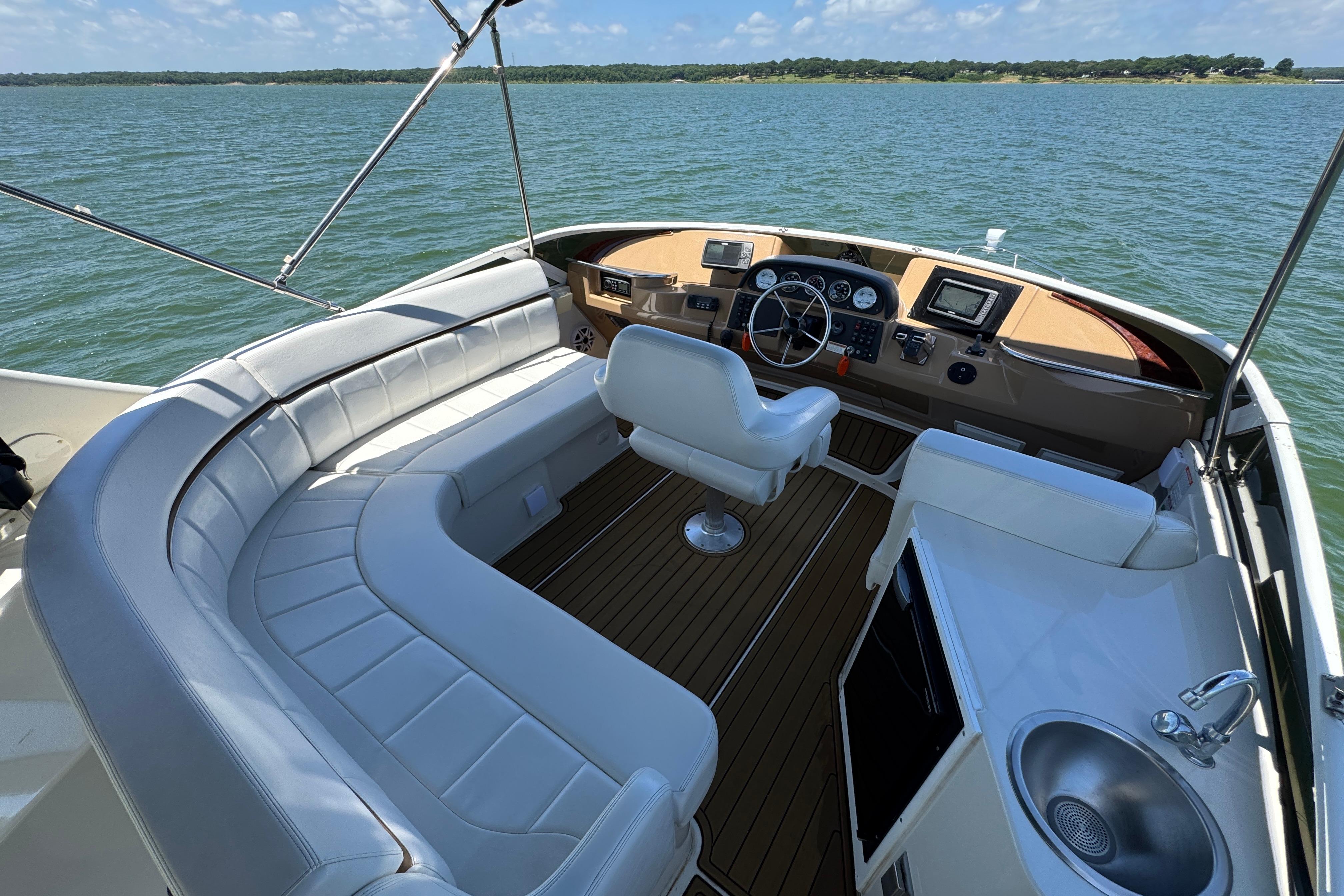 Luxurious 2002 Carver 396 Motor Yacht cockpit with plush seating and modern controls.