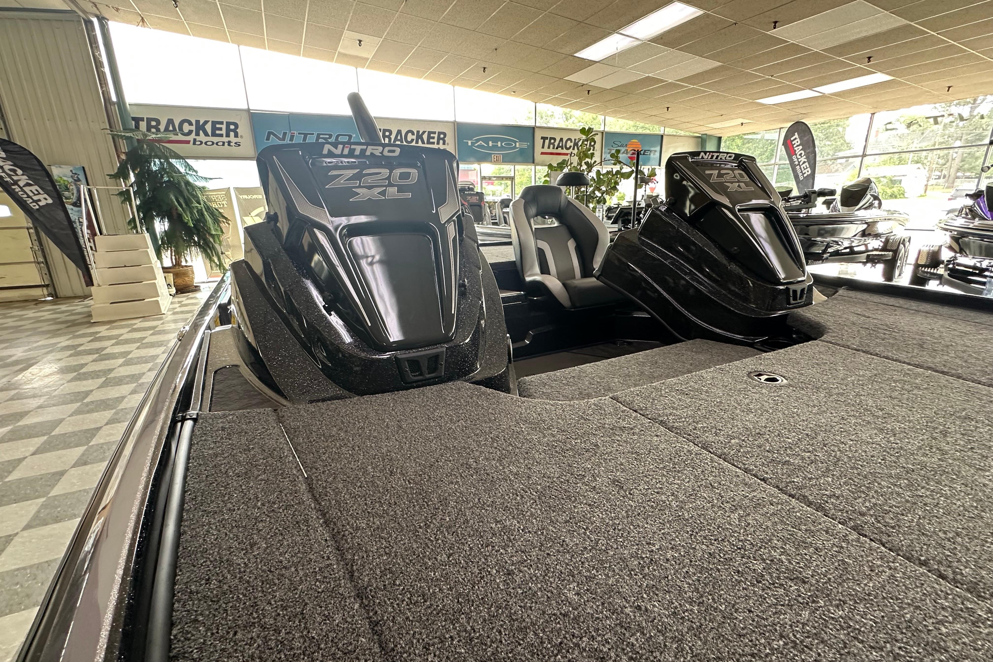 2025 Nitro Z20 XL Pro boat interior in showroom with carpeted deck and seating.