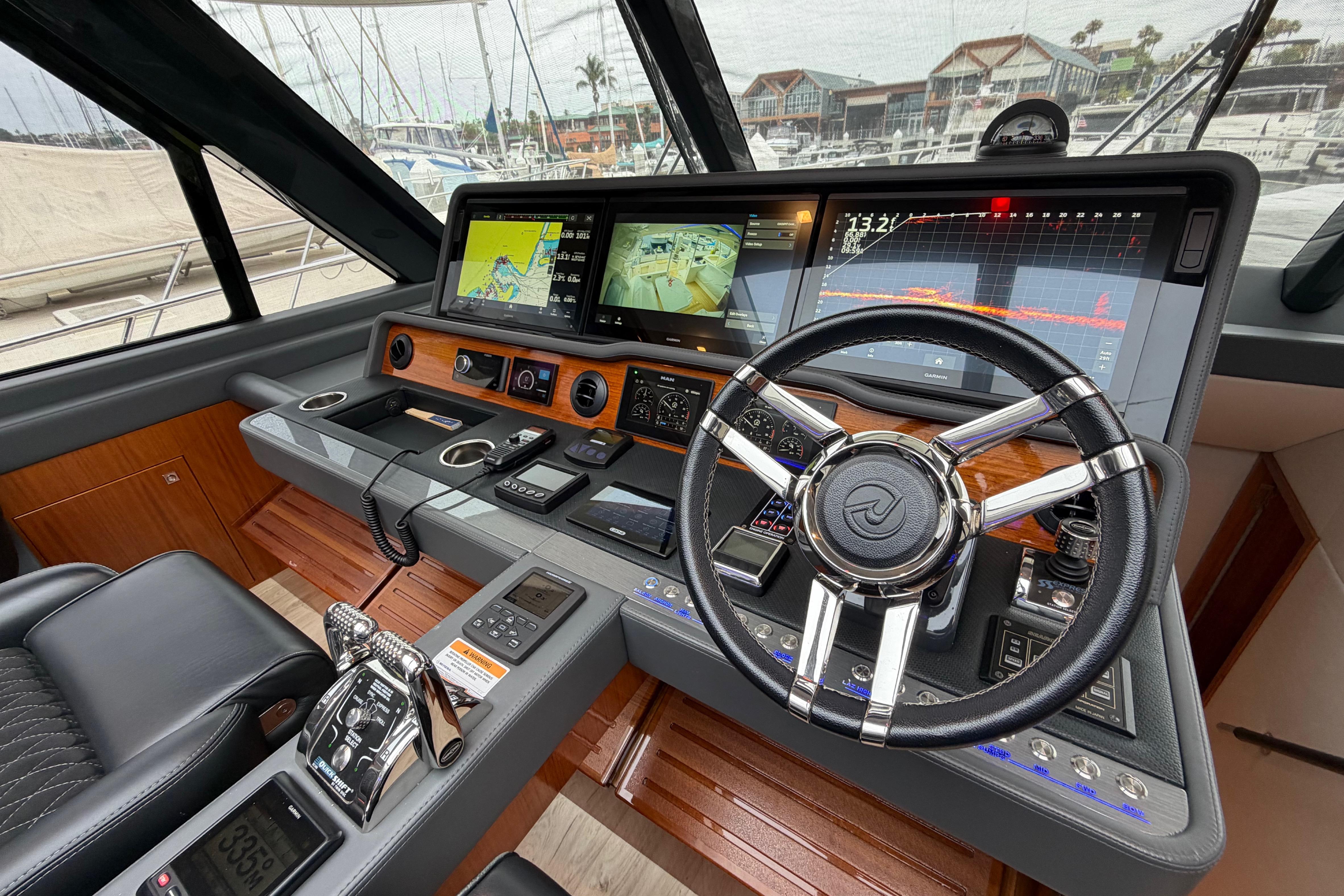 Cockpit of 2023 Riviera 645 SUV yacht with advanced navigation displays and controls.
