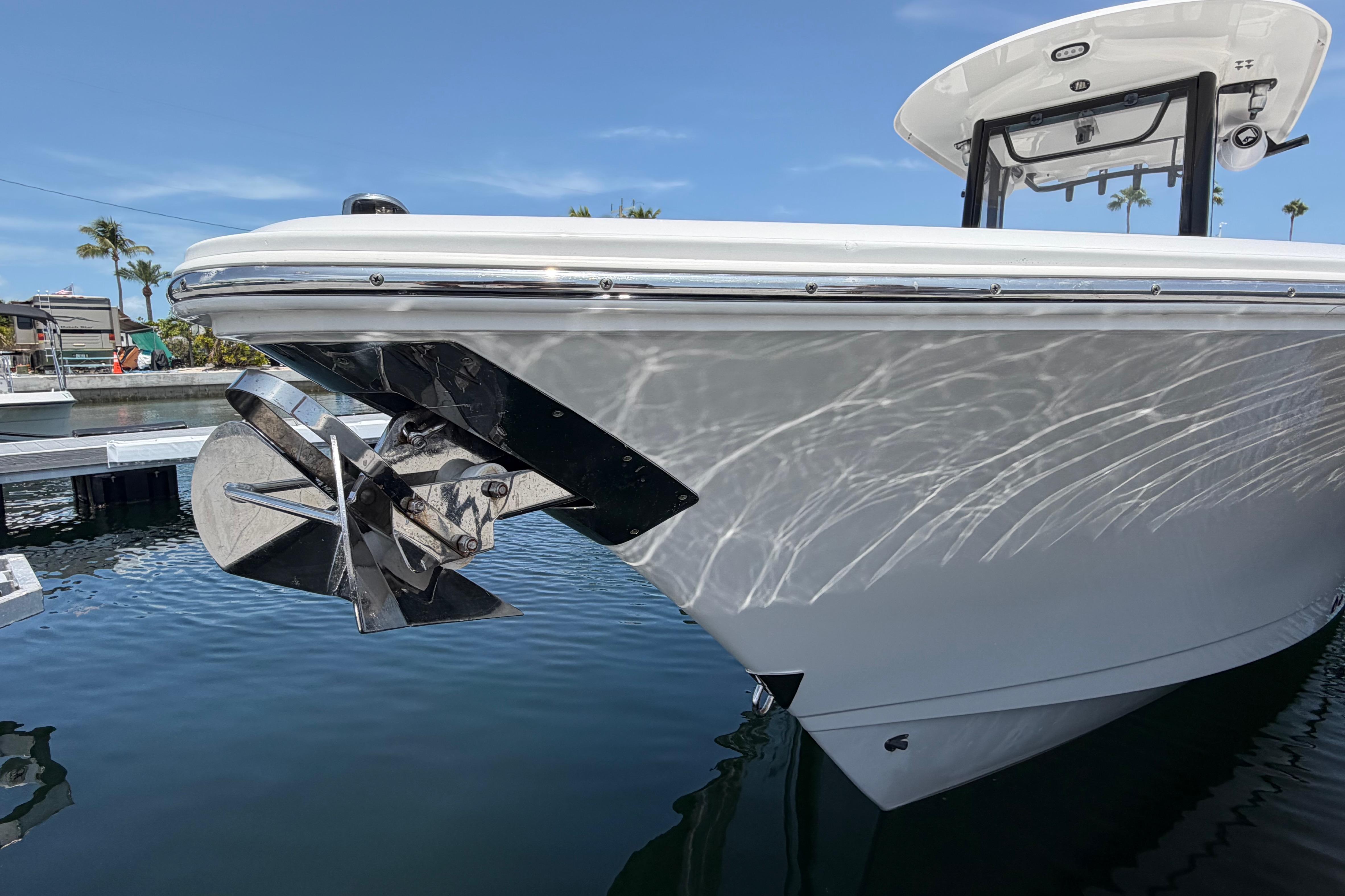2019 Sea Hunt Gamefish 27 Coffin Box boat docked, showcasing sleek hull design and anchor.
