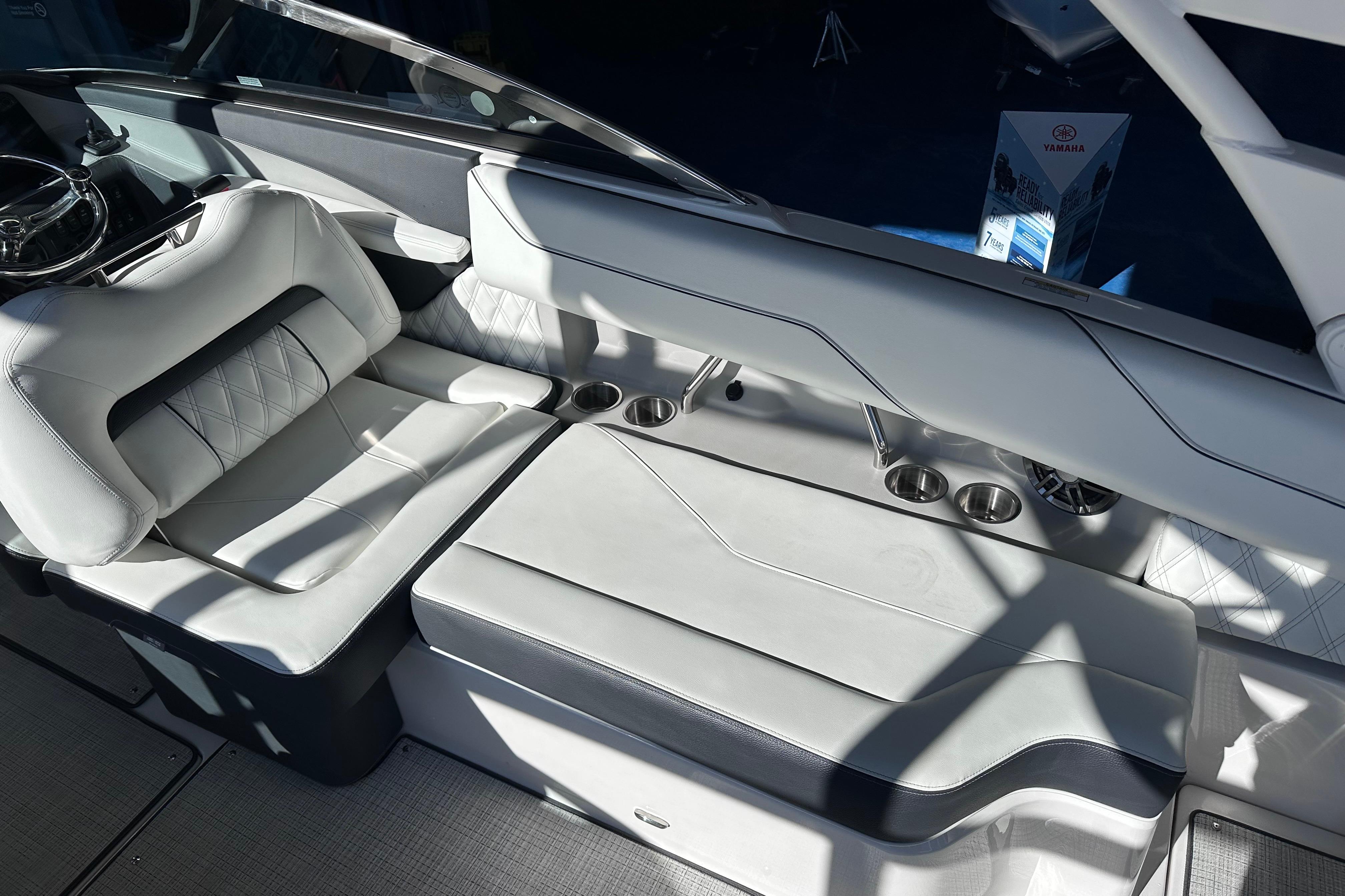 Luxurious interior of 2026 Regal LX4 boat with plush seating and cup holders.