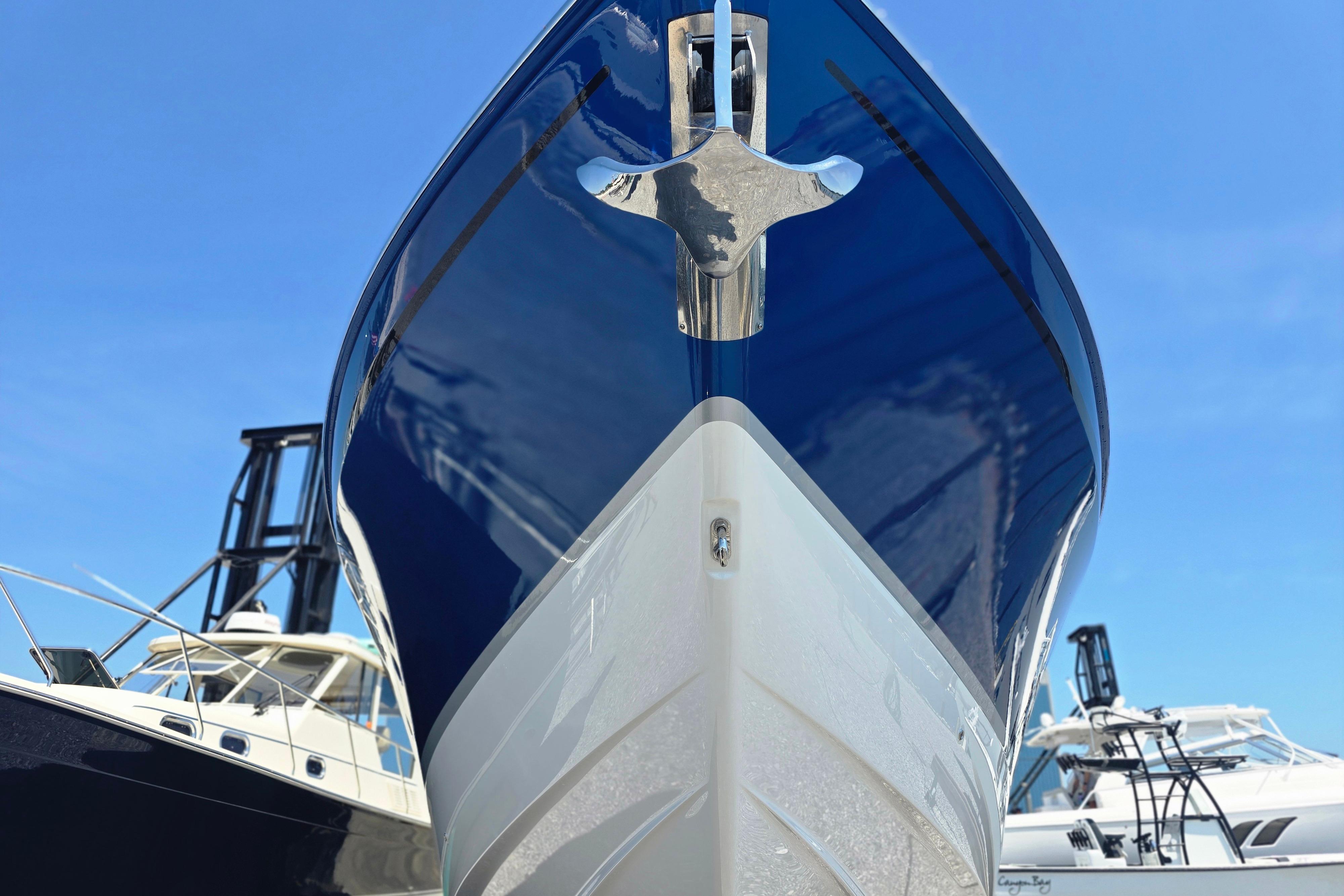 2025 Formula 380 Super Sport Crossover OB boat, sleek design, blue and white hull.