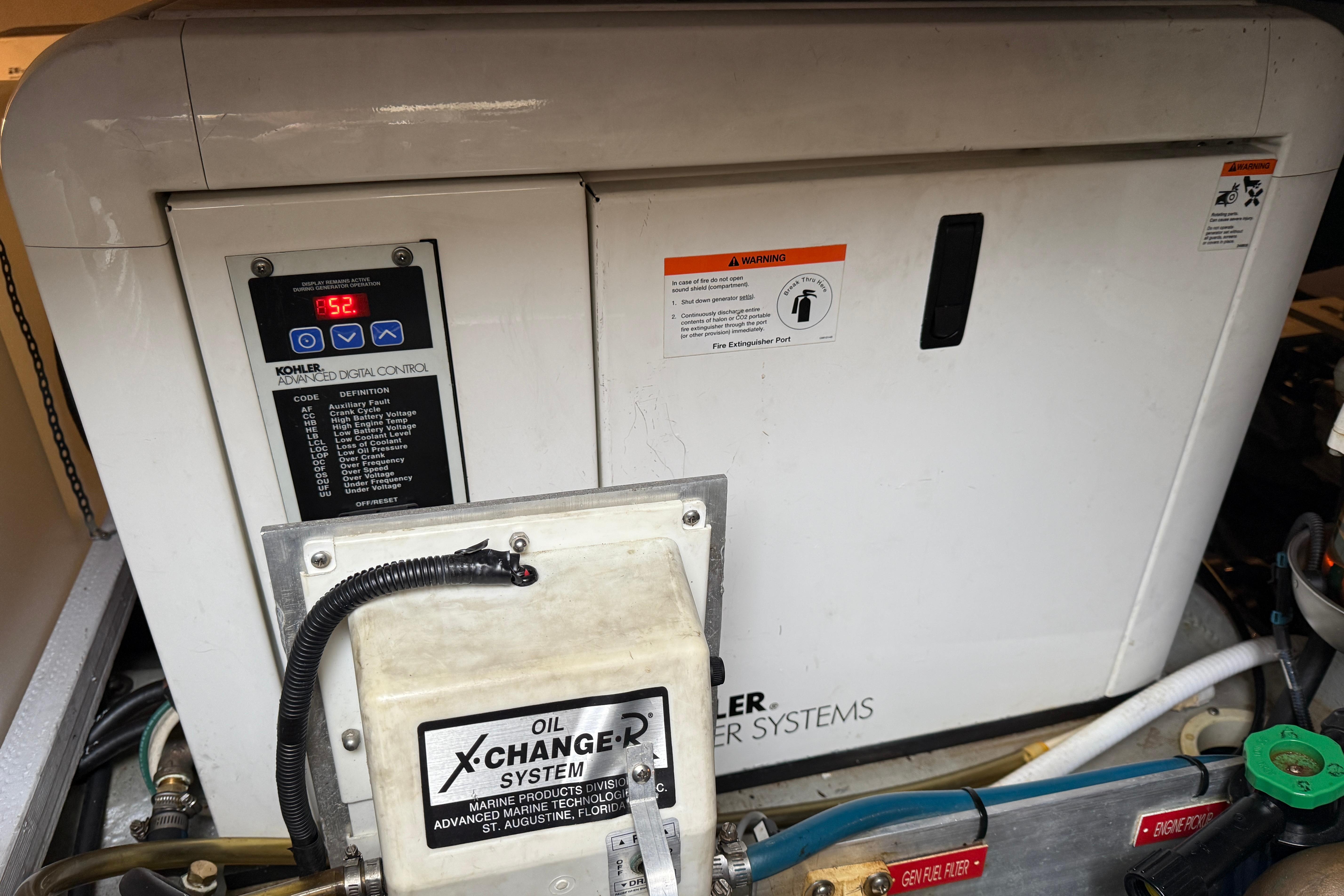 Engine room of 2006 Mainship 34 Trawler with Kohler generator and oil exchange system.