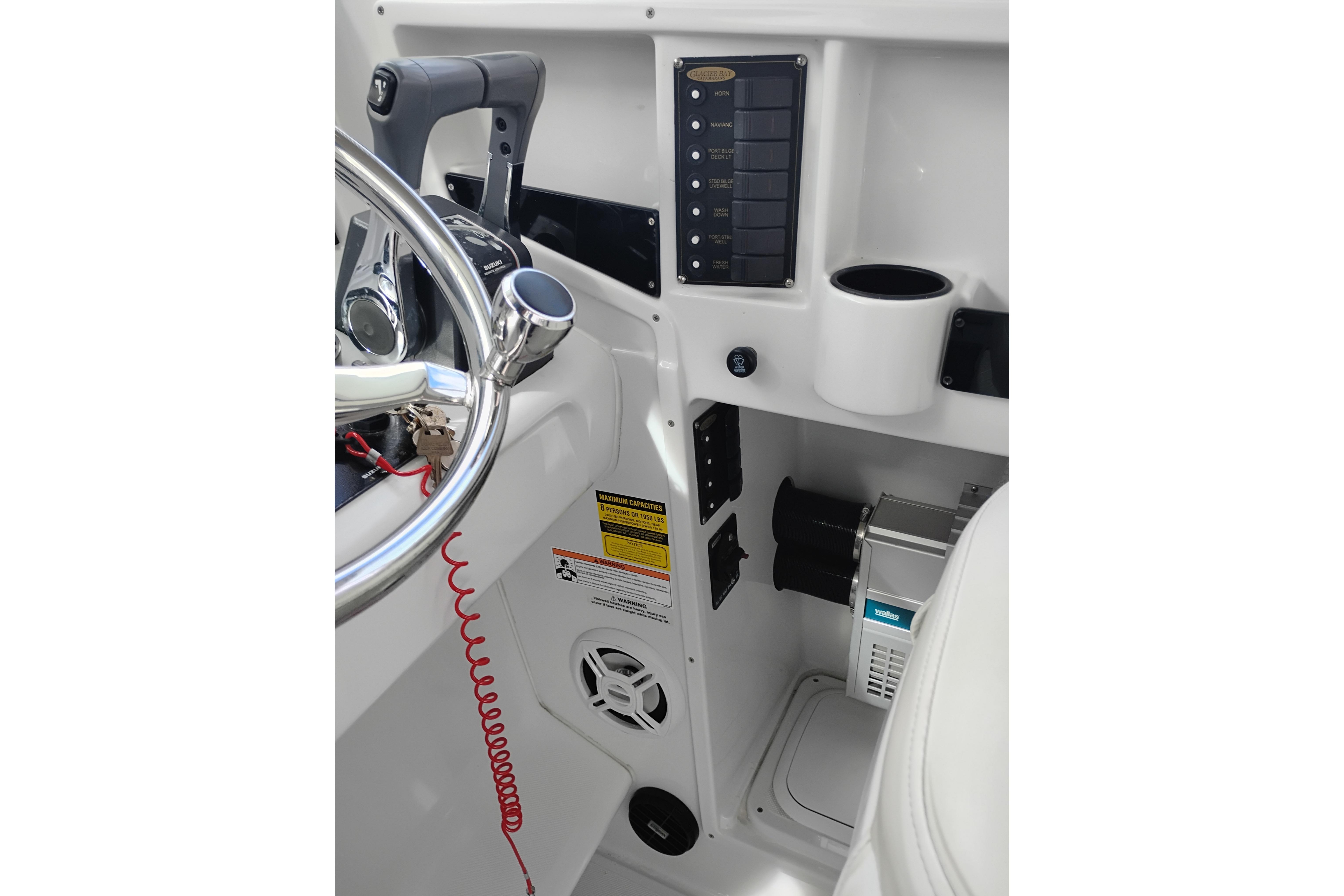 2007 Glacier Bay 2685 Coastal Runner helm with controls and cup holder.