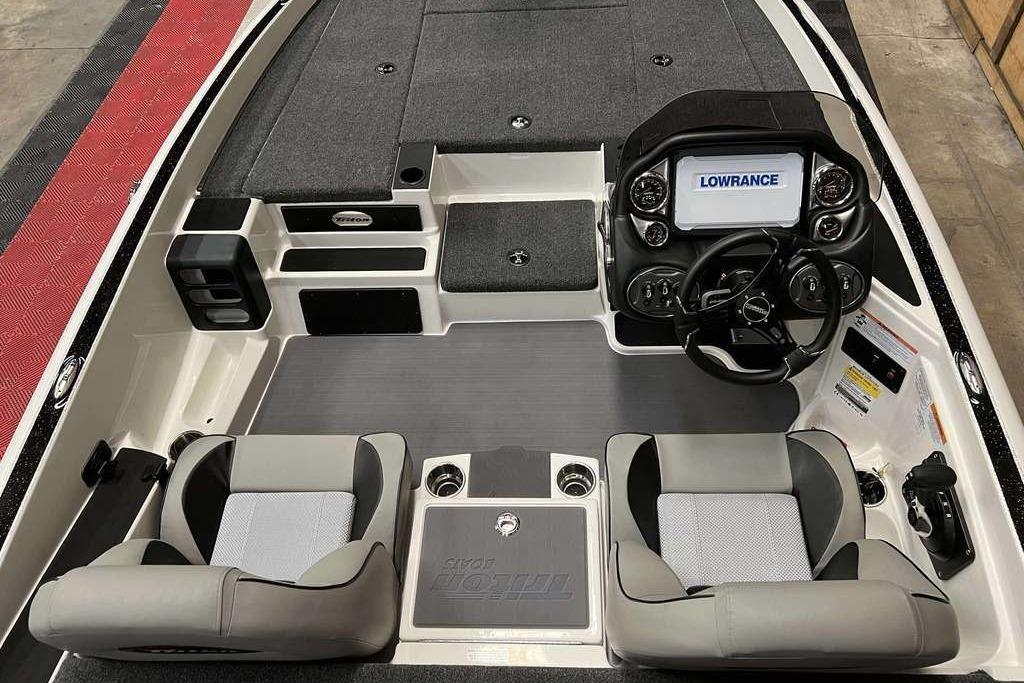 2026 Triton 18 TrX boat interior with dual seats, steering wheel, and Lowrance display.