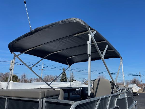 2025 Armada Saphir 23CR pontoon boat with canopy under clear blue sky.