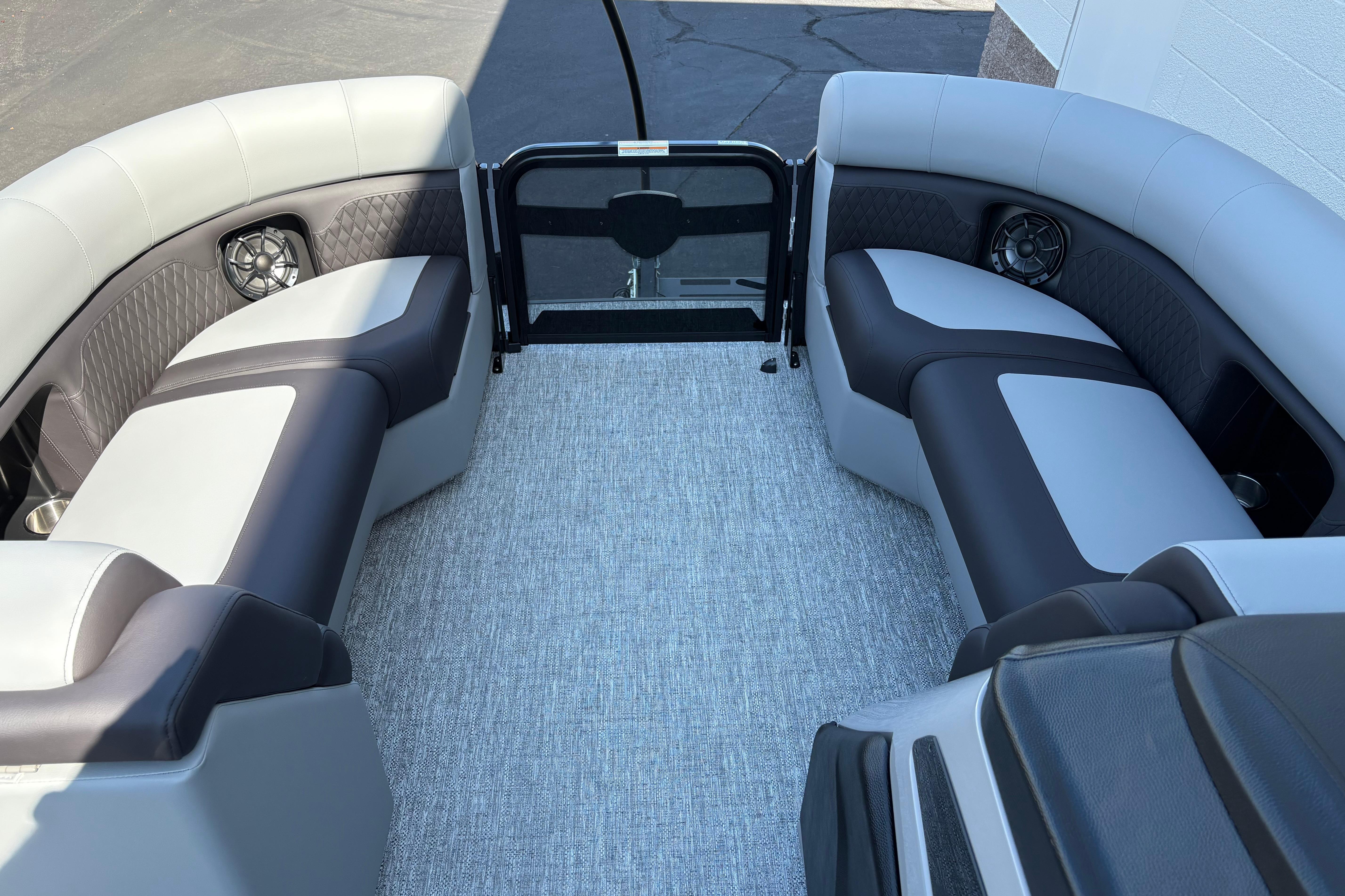 Interior of 2026 Premier 210 Sunsation RF pontoon boat with stylish seating and speakers.