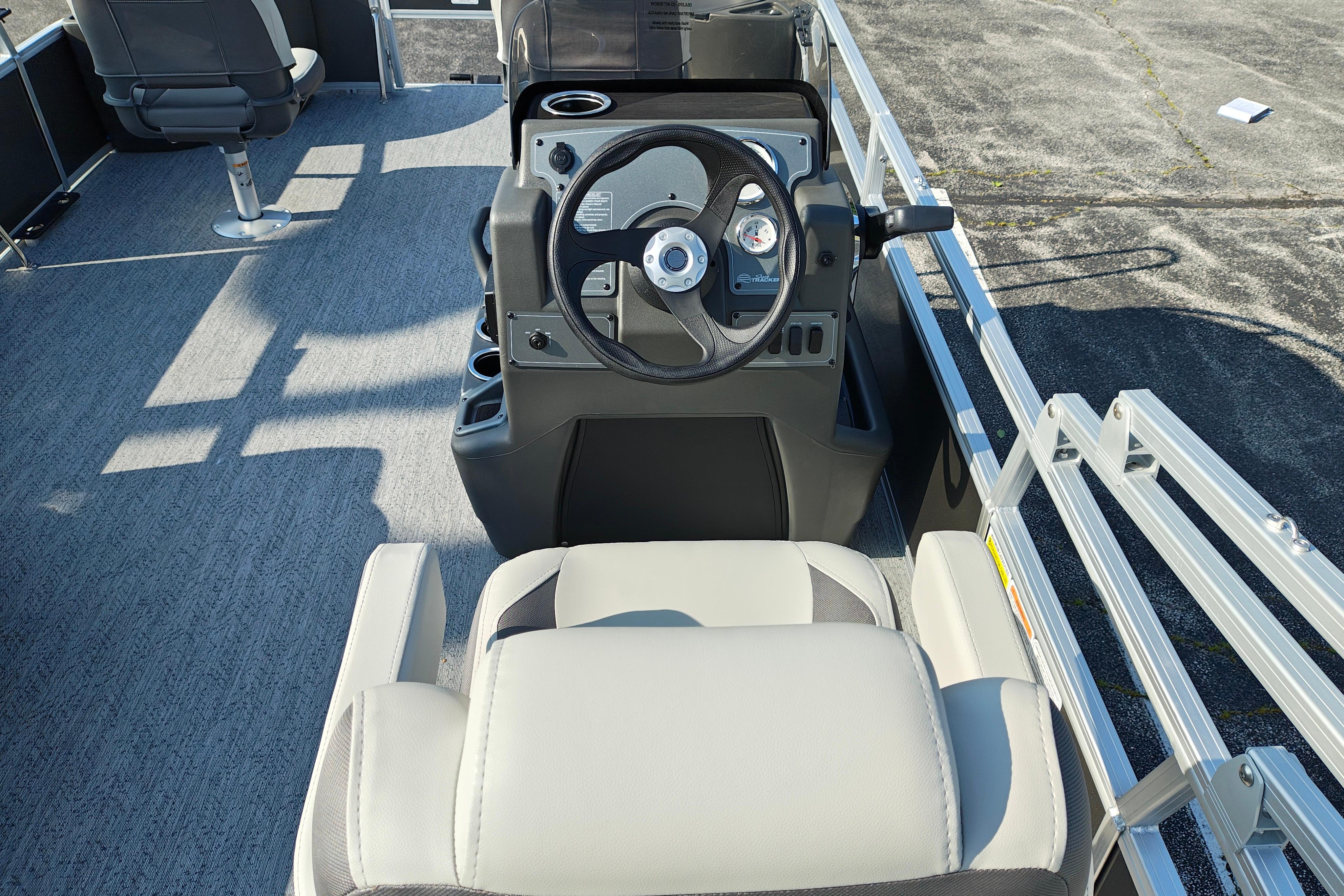 2026 Sun Tracker Bass Buggy 18 DLX pontoon boat interior with steering console and seating.