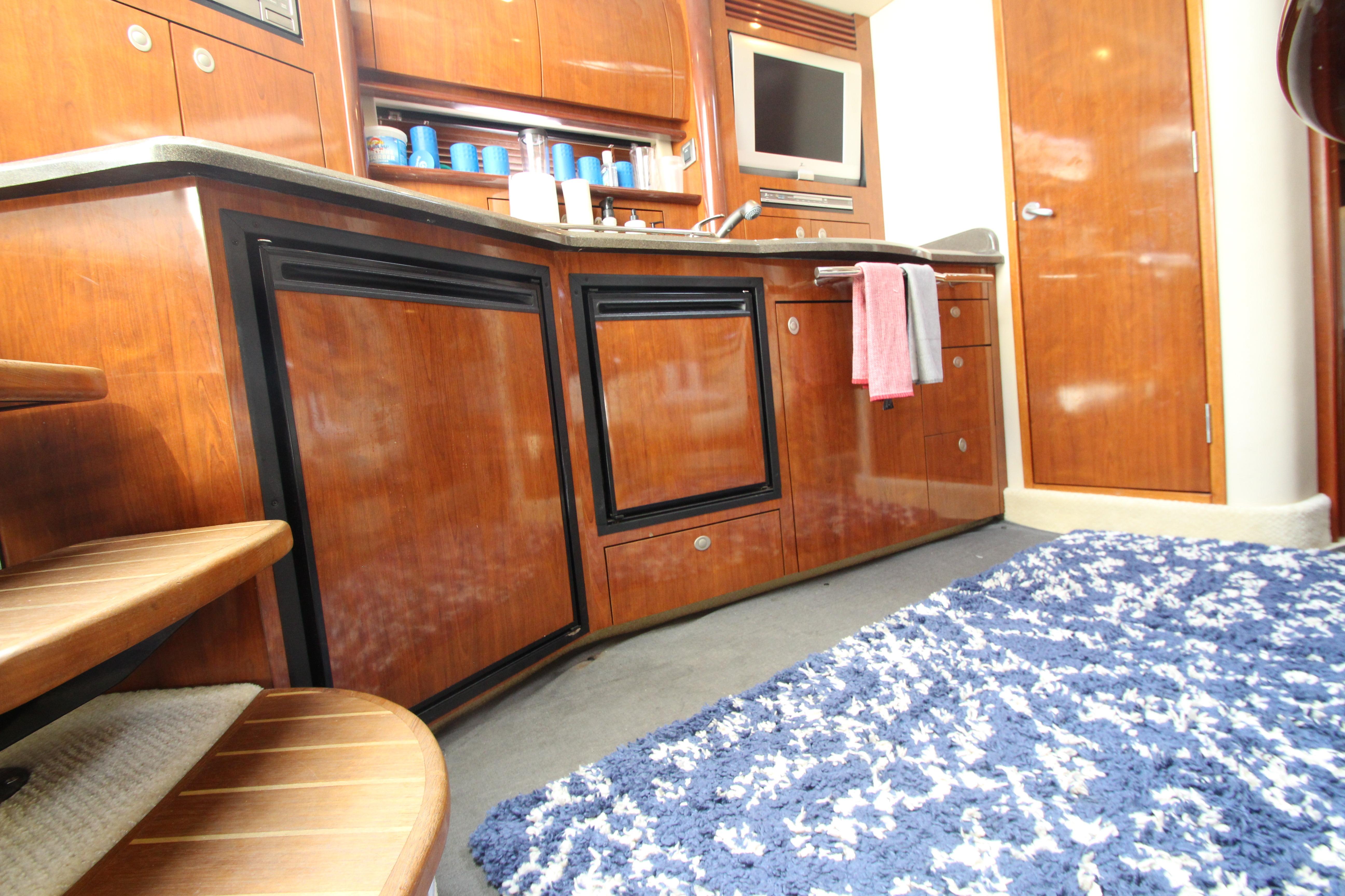 Interior of 2004 Sea Ray 40 Sundancer yacht with wooden cabinetry and modern amenities.