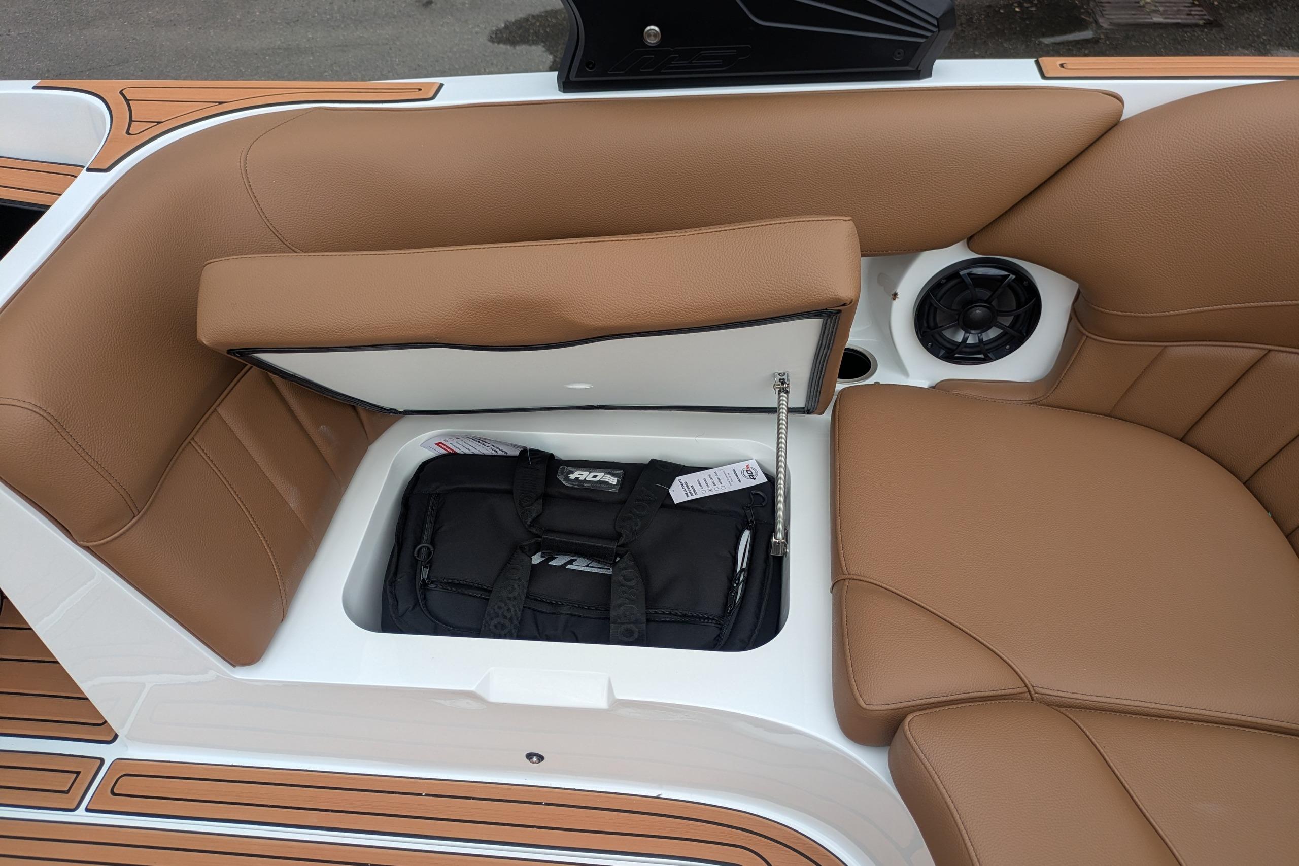 2026 MB B52-23 Classic LIMITED boat interior with tan leather seats and storage compartment.