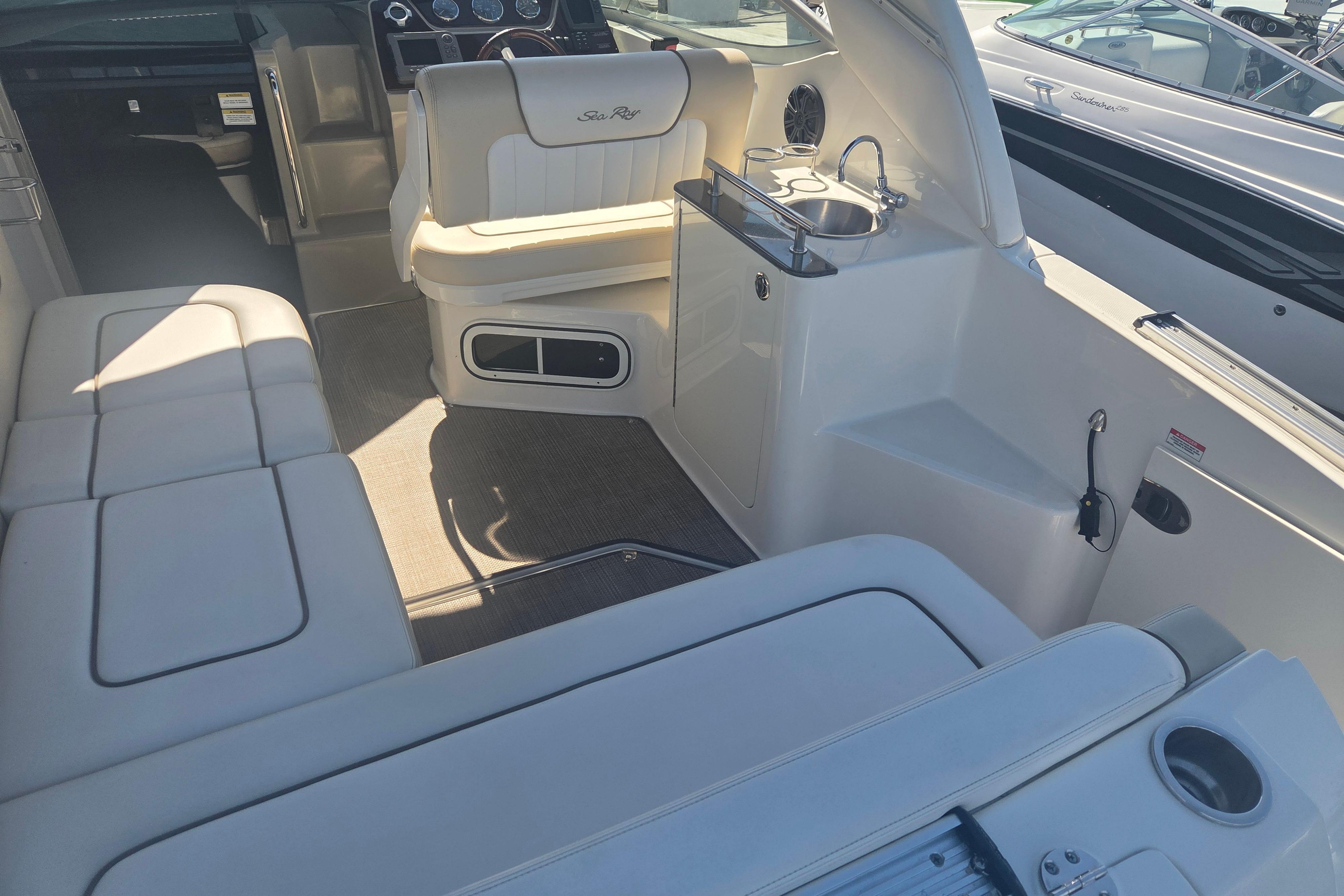 Interior of a 2012 Sea Ray Sundancer 260 boat with seating and kitchenette.