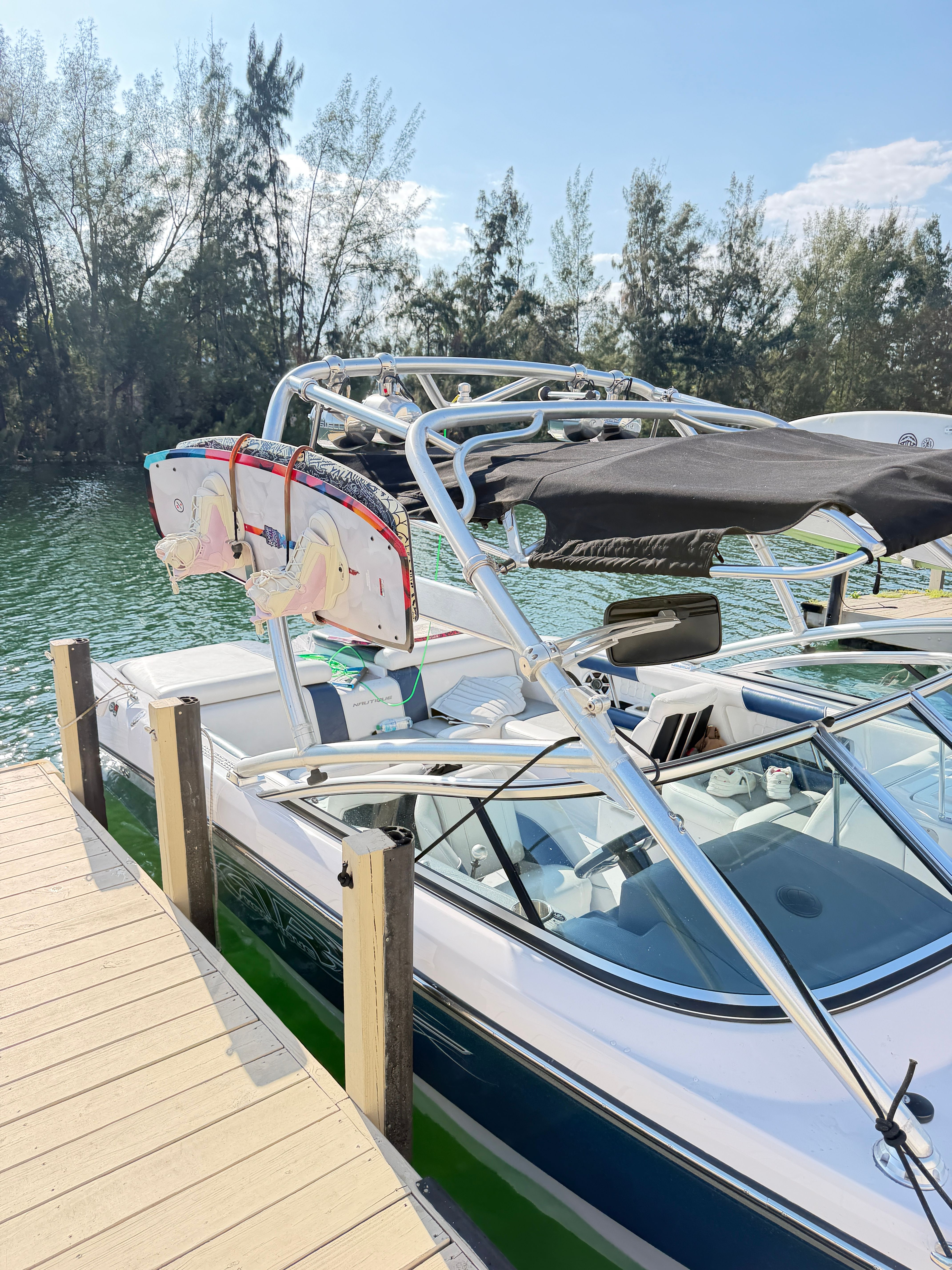 2008 Nautique 236 Team Edition boat docked with wakeboards.