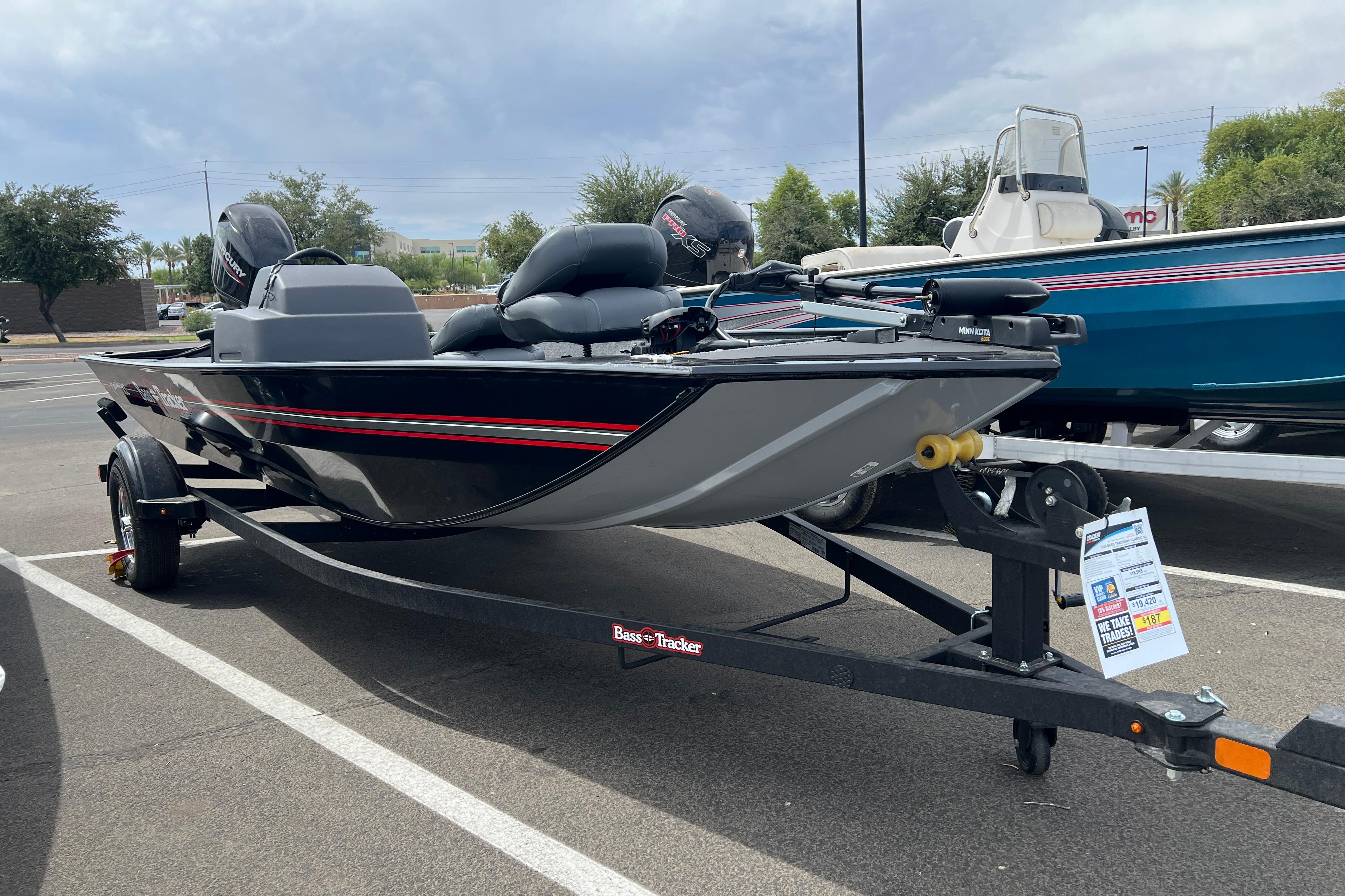 2026 Tracker Bass Tracker Classic XL boat on trailer in parking lot.