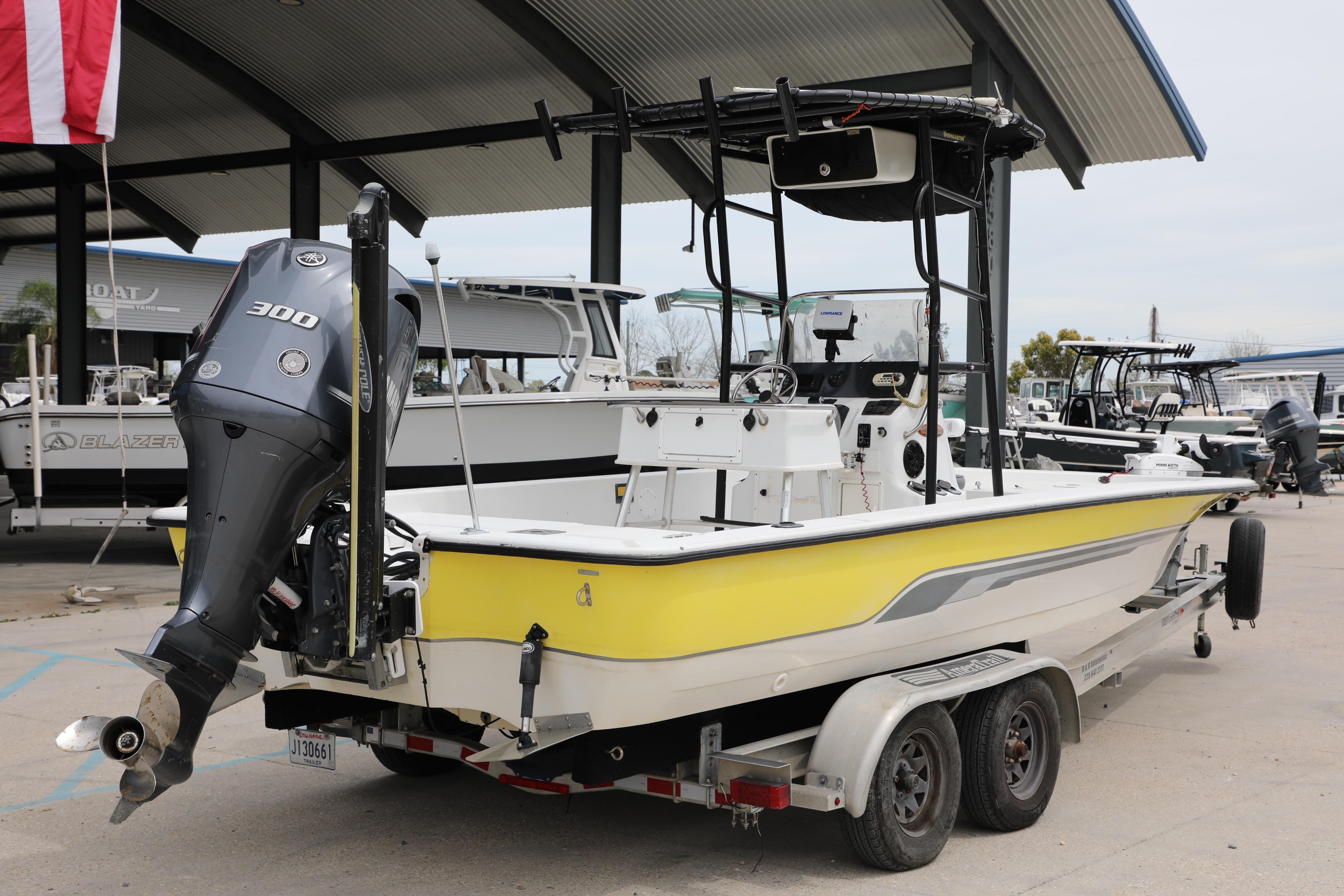 2002 Ranger 2300 Bay Ranger boat with powerful outboard motor on trailer.