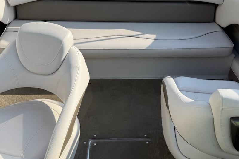 Interior of a 2012 195 SS boat with white seating and carpeted floor.