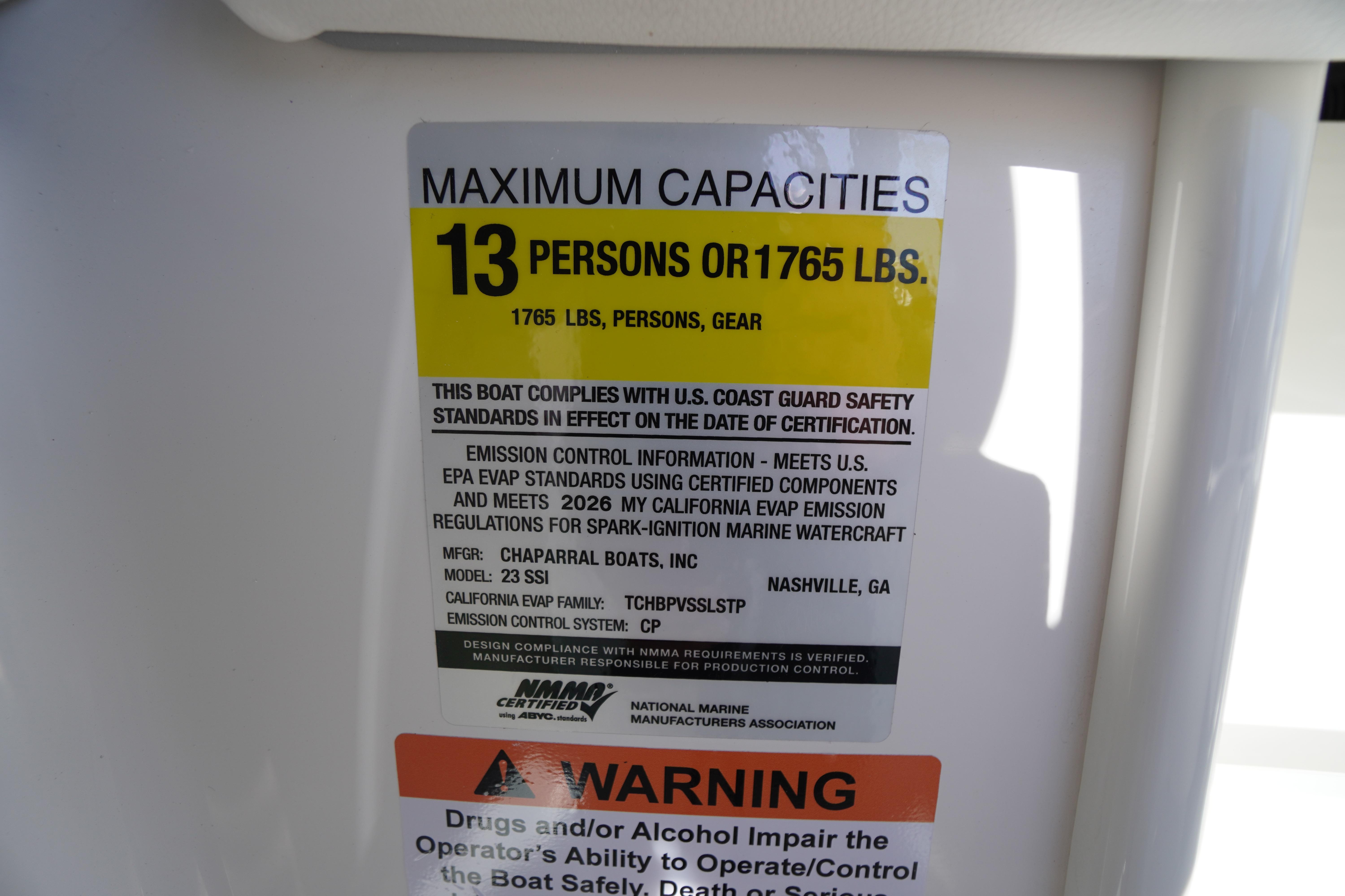 2026 Chaparral 23 SSi boat capacity label, 13 persons or 1765 lbs, safety compliance.