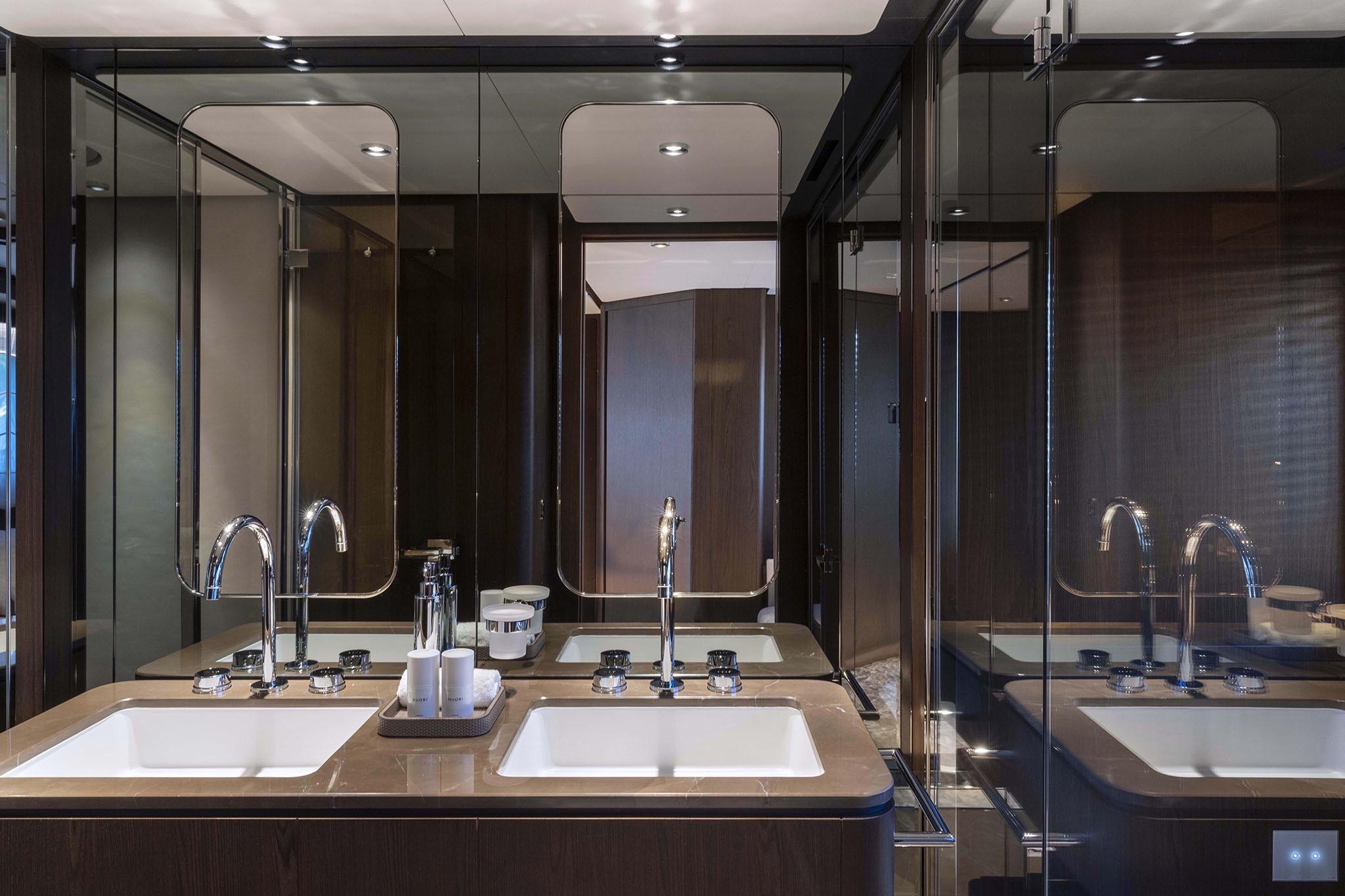 Luxurious bathroom interior of 2023 Ferretti 860 yacht with dual sinks and modern fixtures.