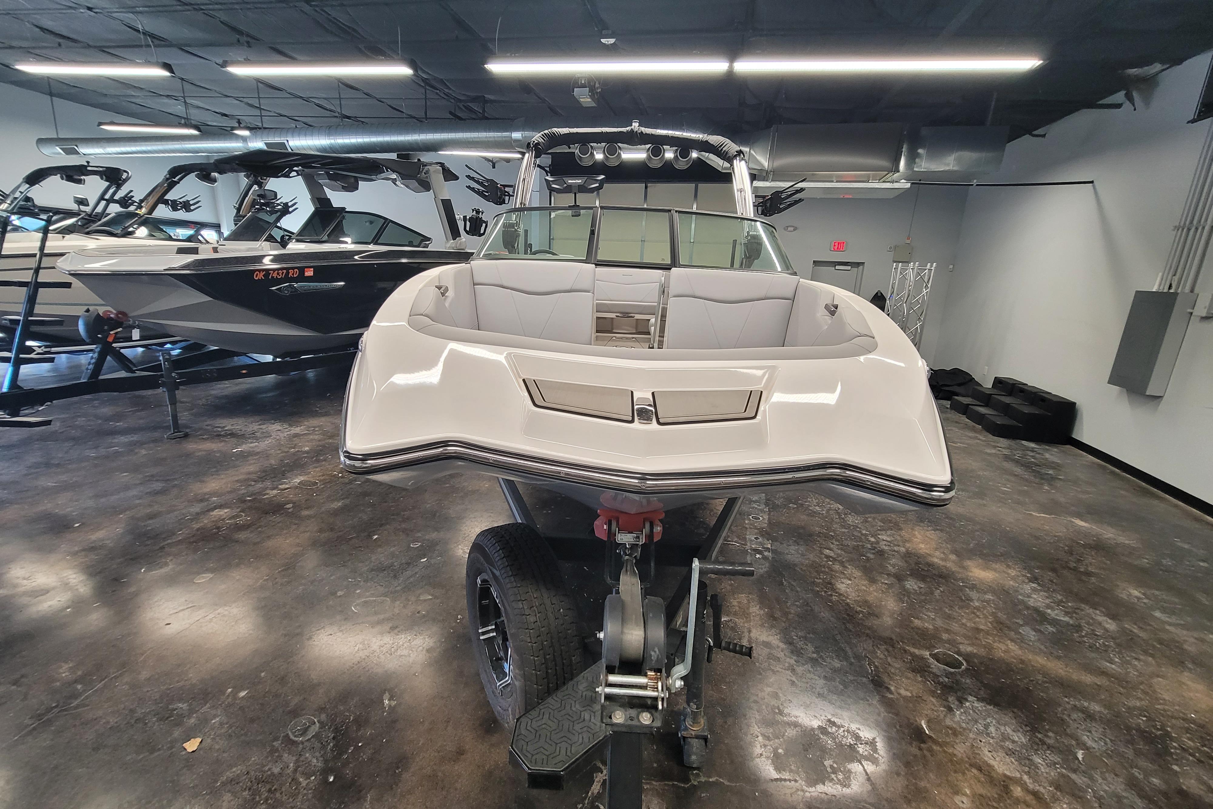 2024 MasterCraft NXT24 boat displayed in a showroom, front view.