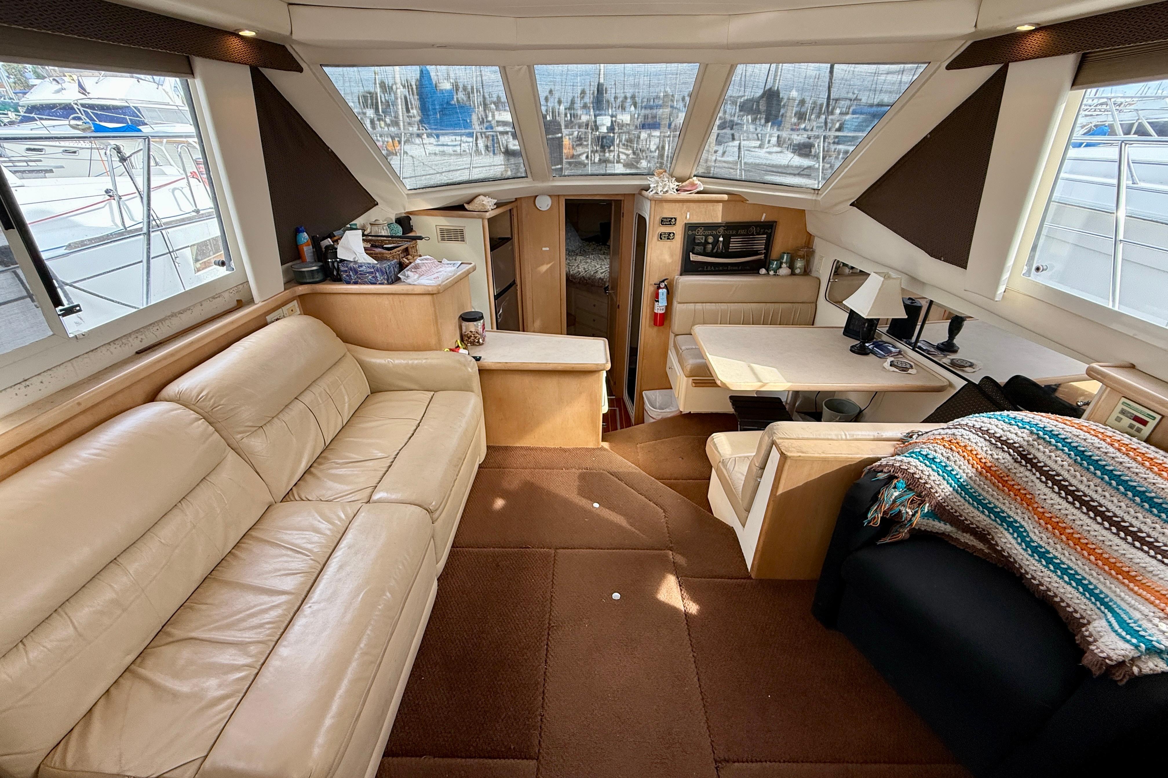 Interior of 1997 Carver 355 Aft Cabin Motor Yacht with beige seating and dining area.