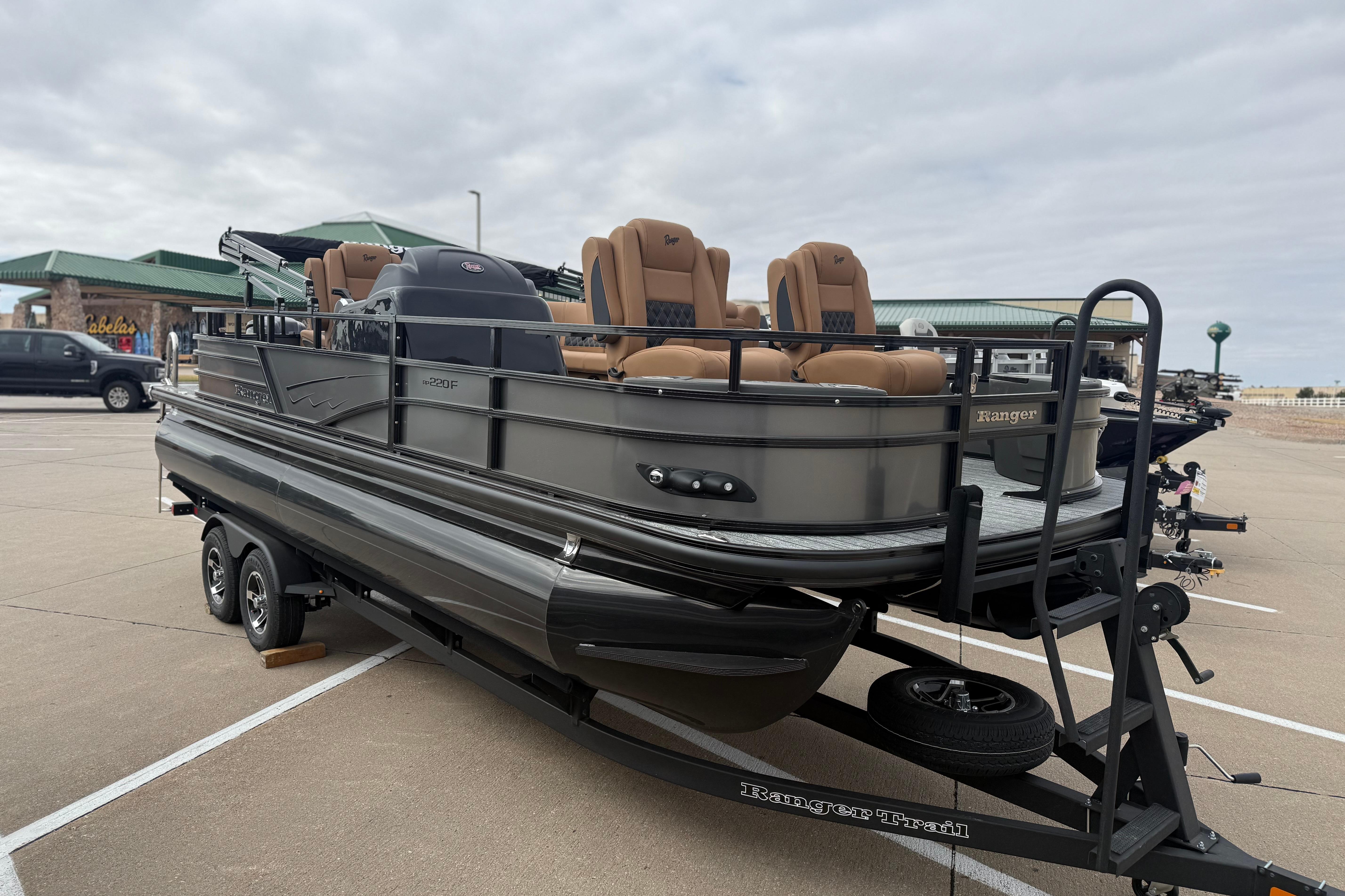 2026 Ranger 220F pontoon boat on trailer in parking lot.