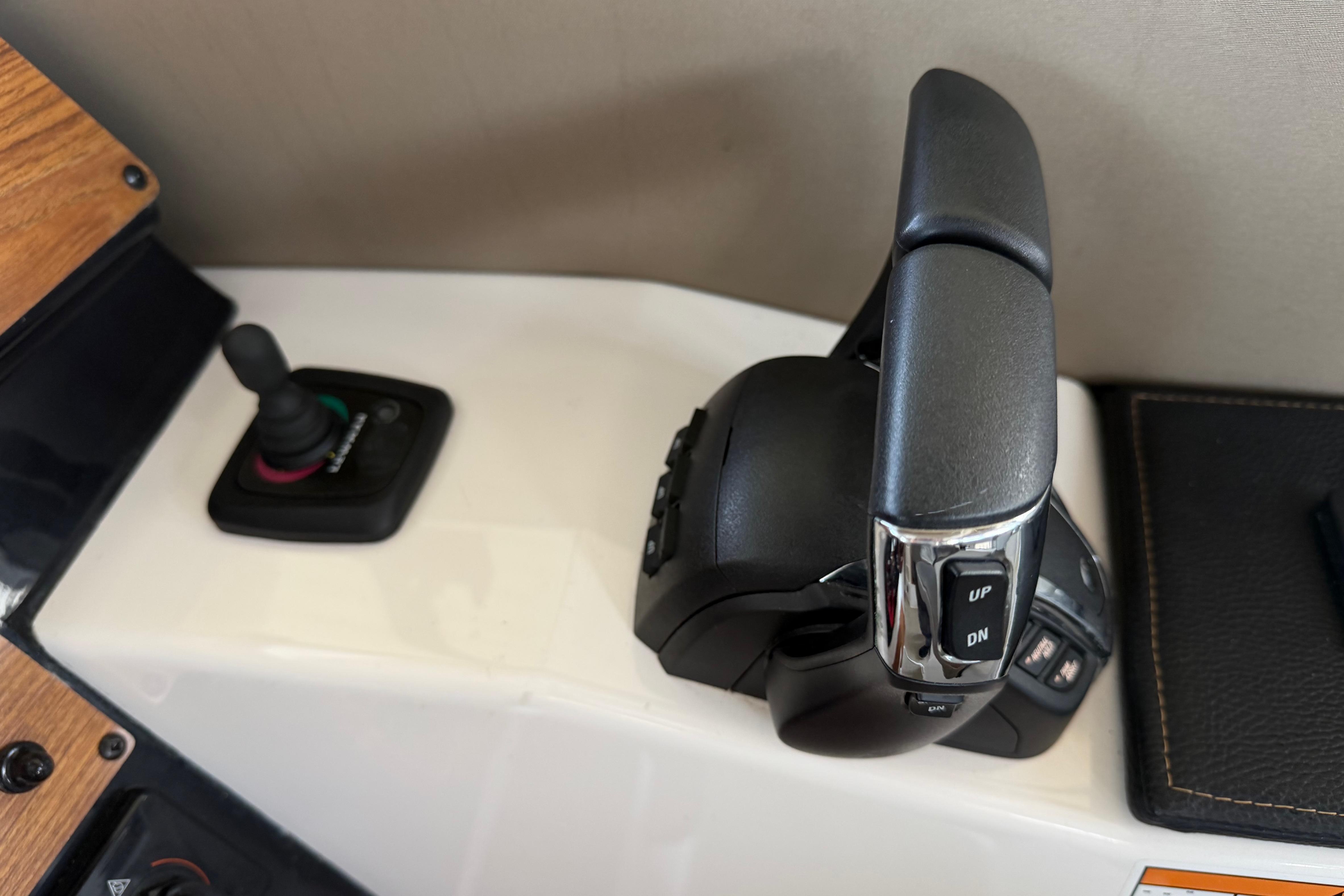 2023 Cutwater C-288 Coupe throttle and joystick controls on a sleek dashboard.
