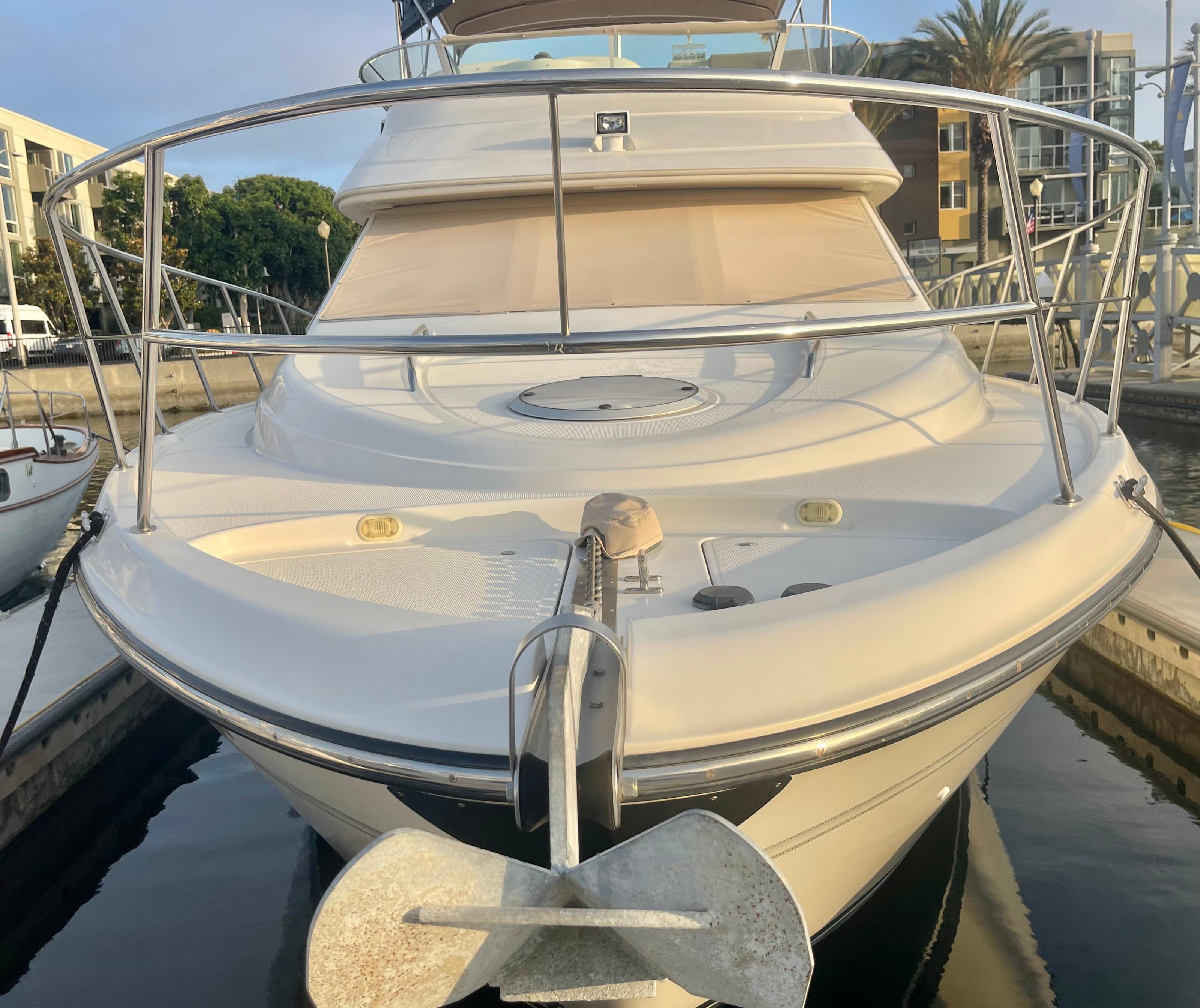 1998 Maxum 4100 SCA yacht docked, front view with anchor and railing.