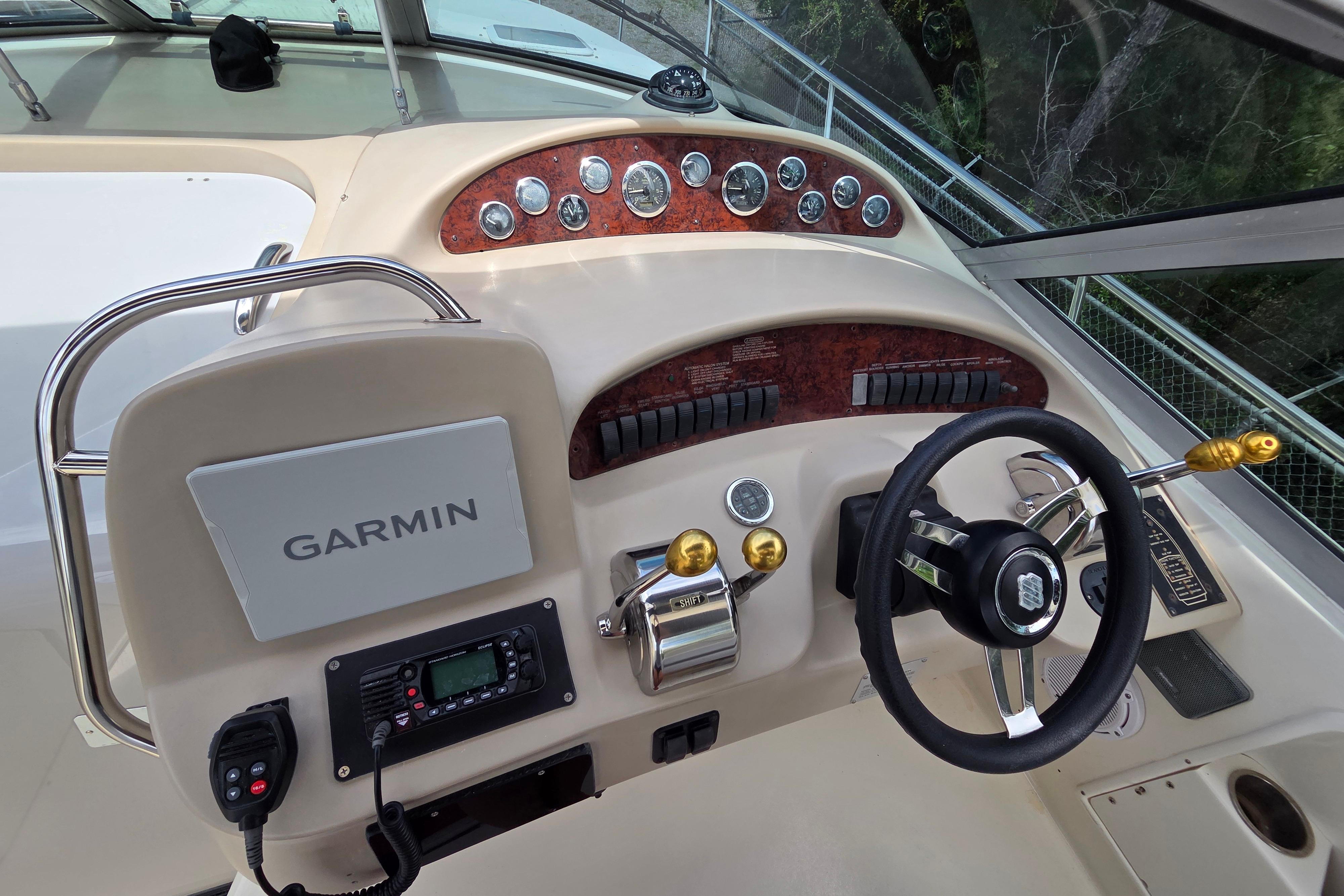 Helm of 2000 Sea Ray 340 Sundancer with Garmin navigation system and control panel.