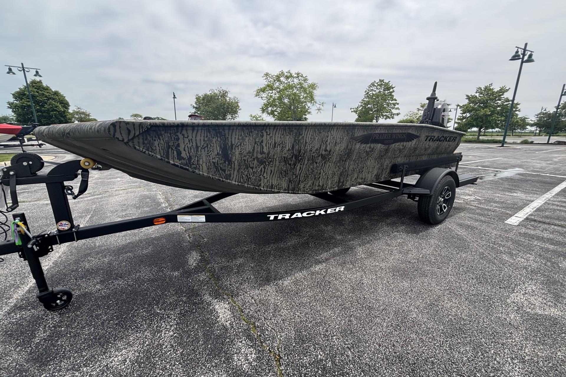 2026 Tracker Grizzly 1650 T Prairie Wings Edition boat on trailer in parking lot.