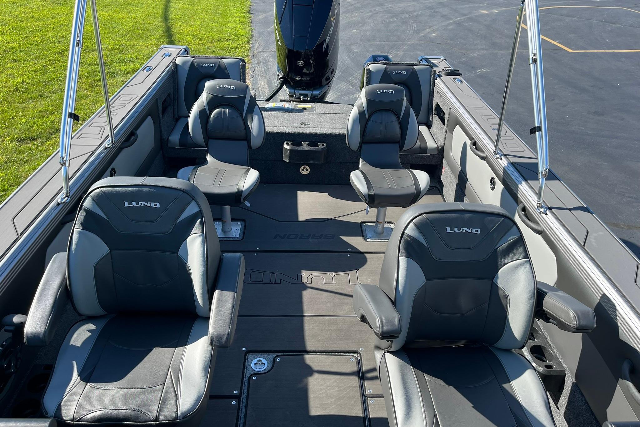 2026 Lund 2275 Baron boat interior with four cushioned seats and sleek design.