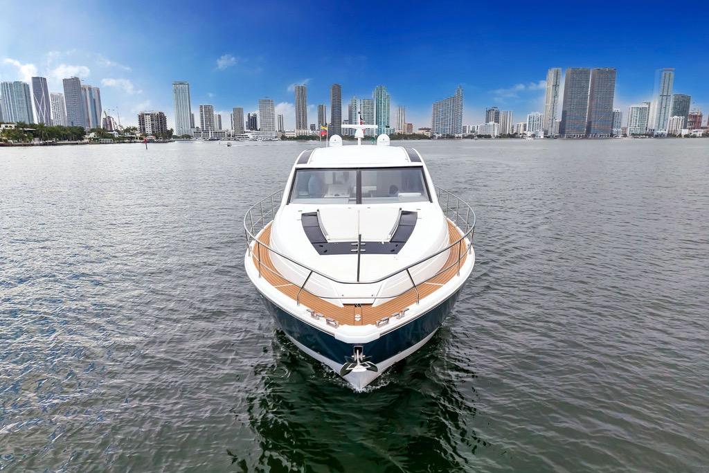 2012 Fairline Targa 58 yacht on water with city skyline backdrop.