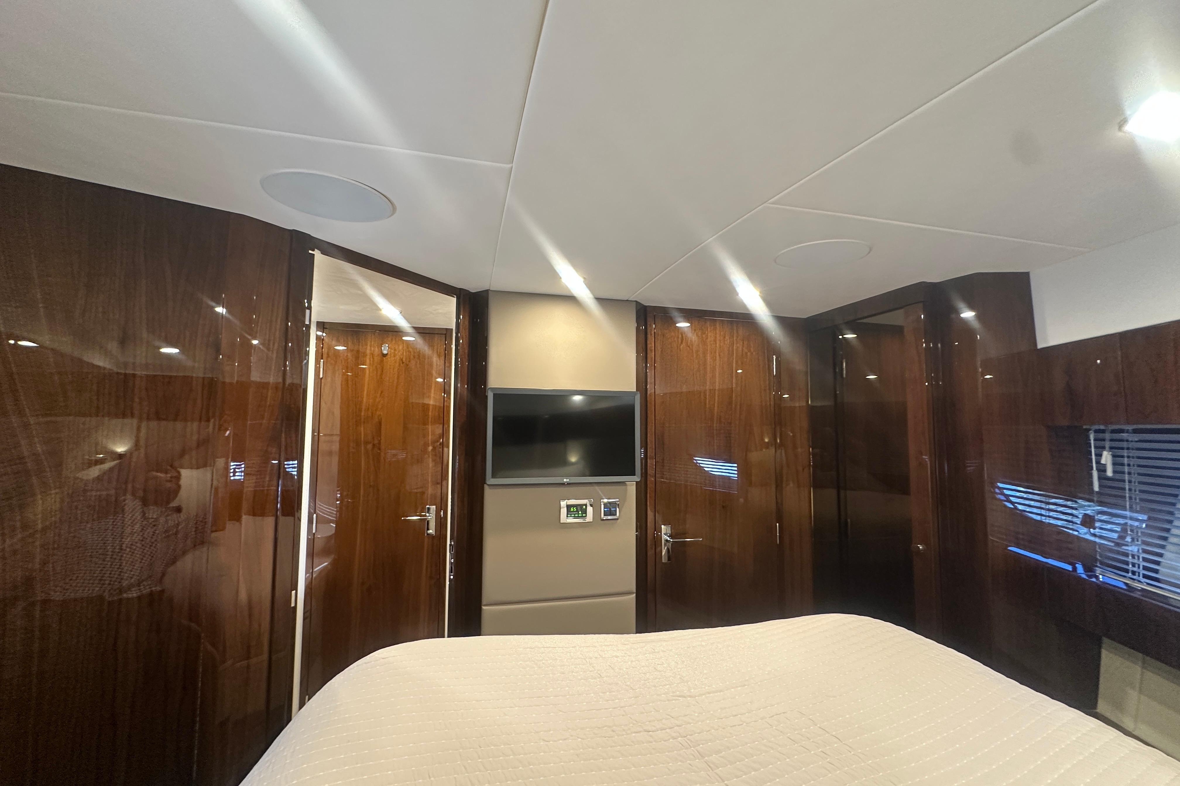 Luxurious interior of 2024 Fairline Squadron 50 yacht with wood paneling and modern amenities.