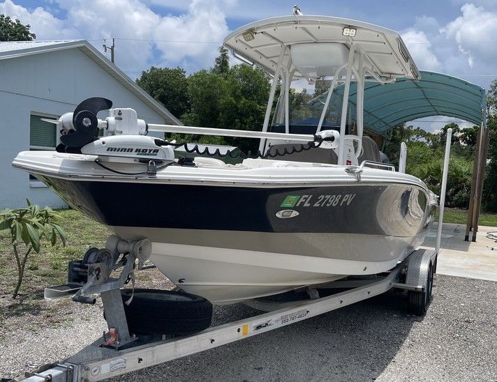 A 2015 NauticStar 231 Coastal on a trailer, featuring a white and blue hull.
