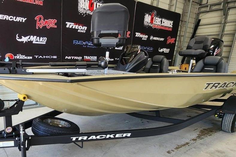 2026 Tracker Pro Team 195 boat on trailer in showroom setting.