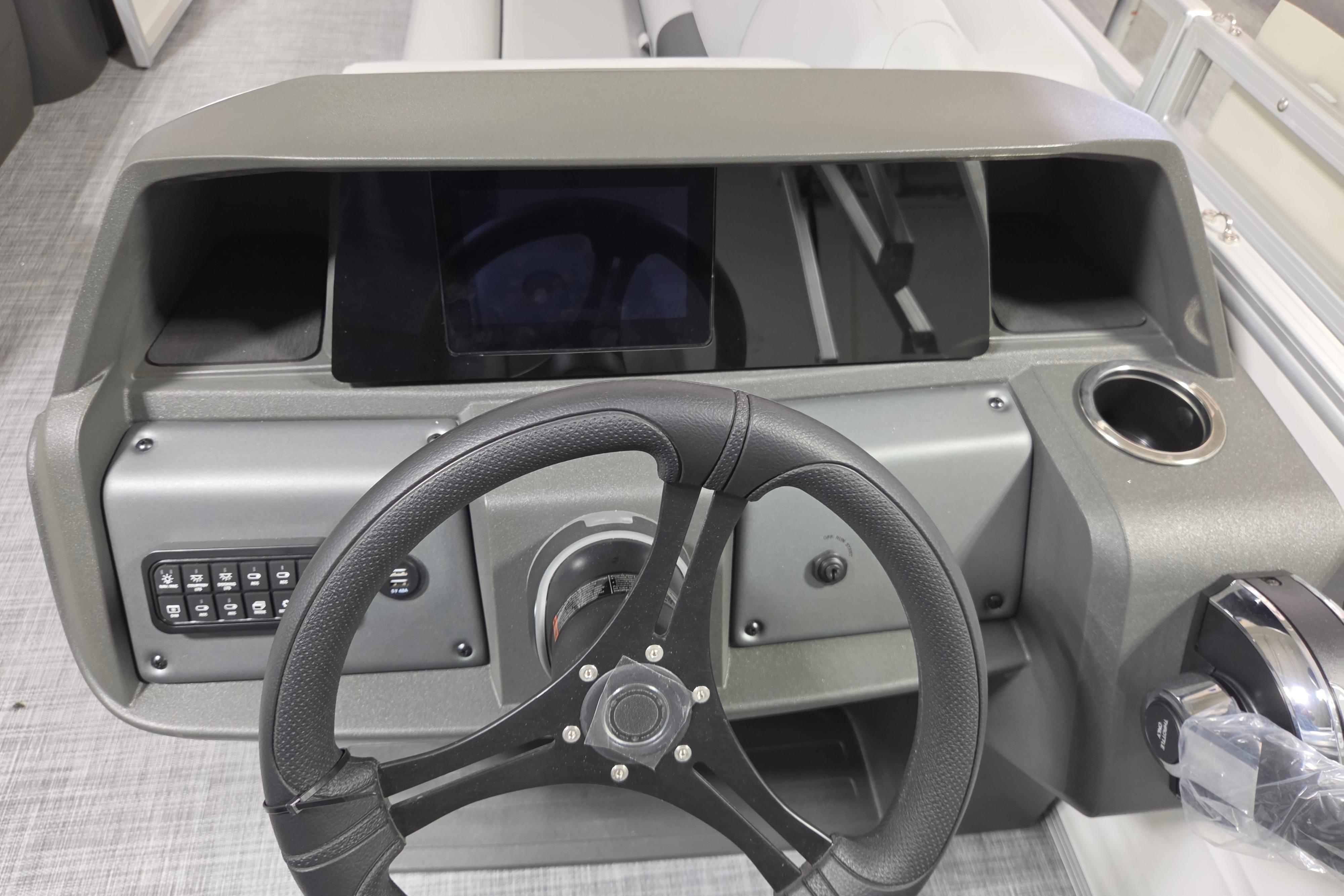 2026 Sun Tracker Party Barge 20 DLX dashboard with steering wheel and control panel.
