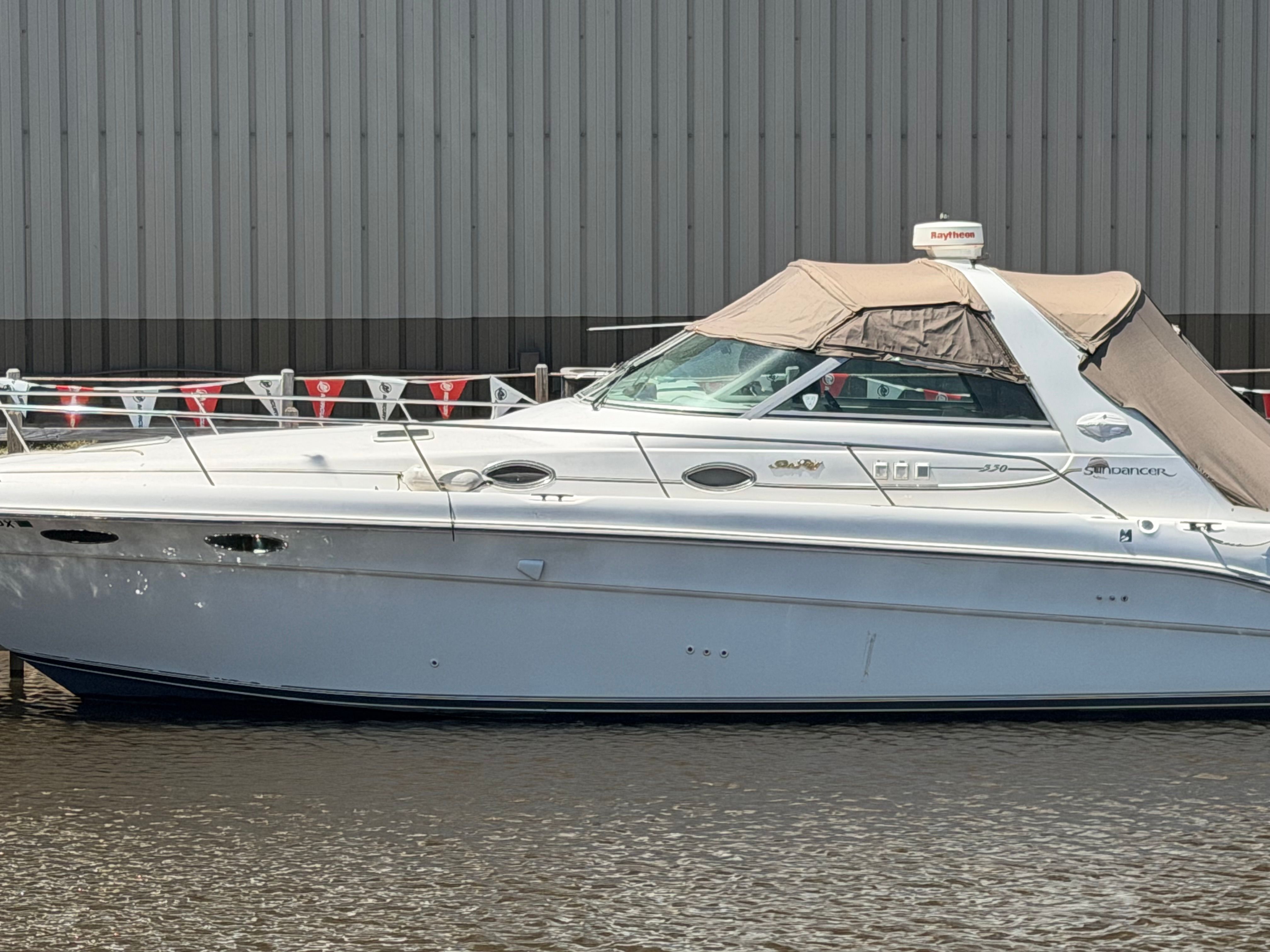 1996 Sea Ray Sundancer 330 yacht docked at harbor.