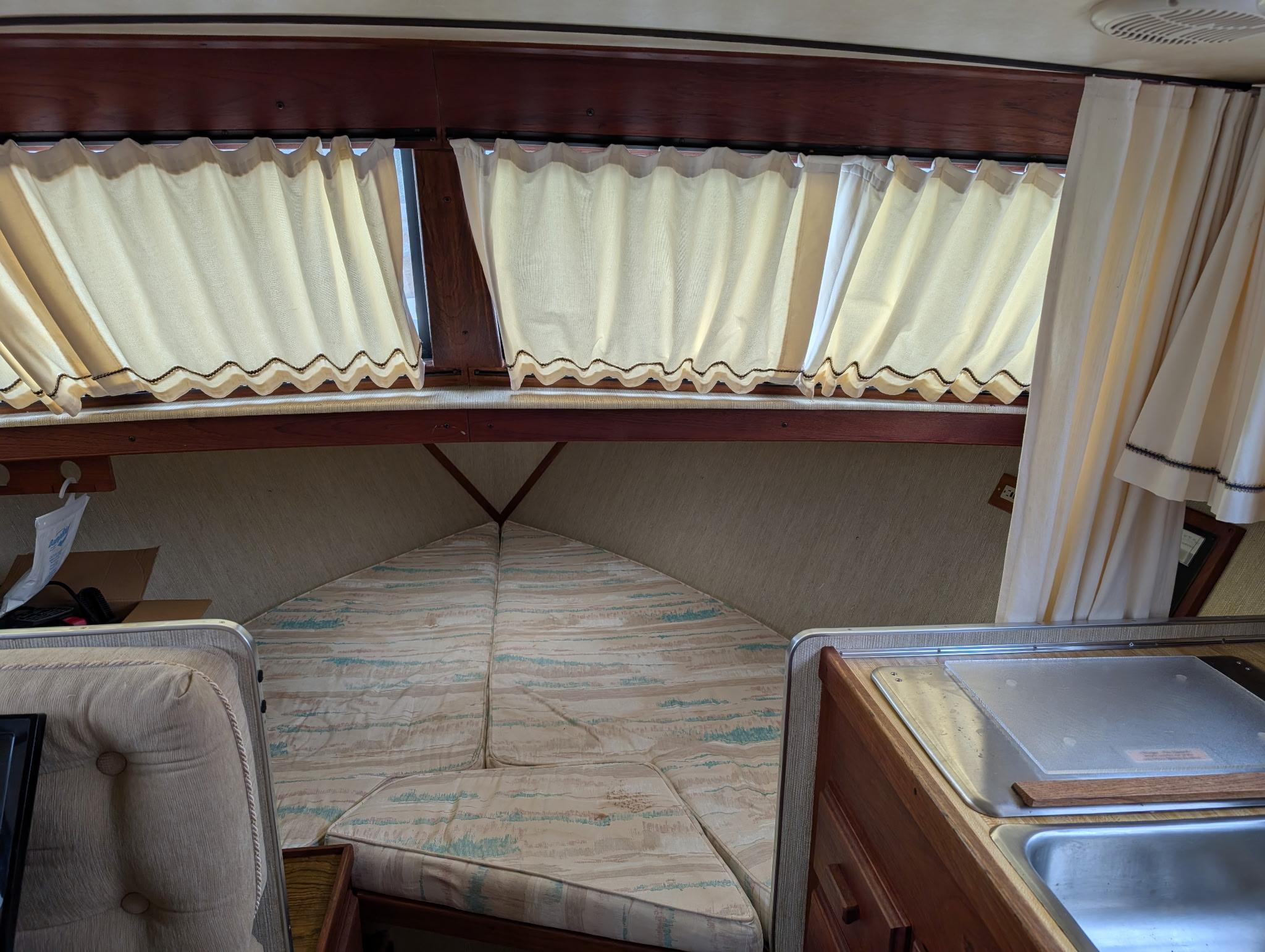 1989 Marinette 28 Sport Fish Fly Bridge interior with cozy cabin and kitchenette.