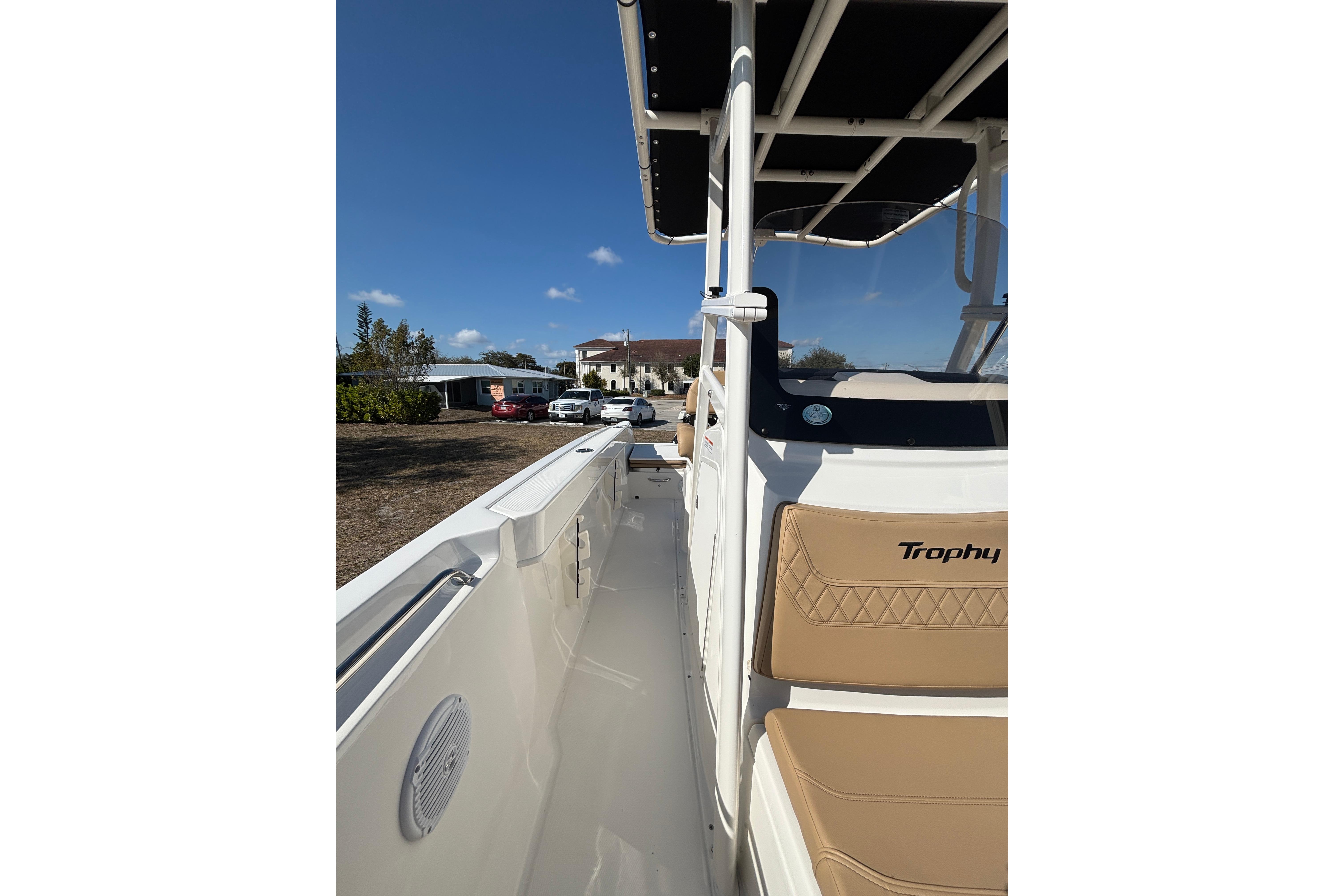 2026 Bayliner Trophy T22CC boat with tan seating and sleek design under clear blue sky.